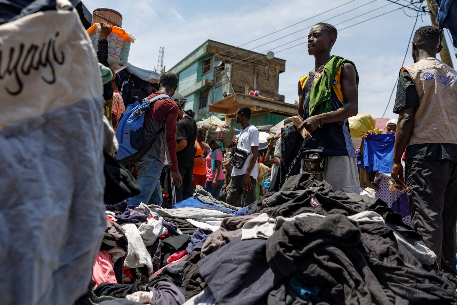 A head porter carries a bale of Second-hand clothes at Kantamanto market, one of the world's largest second-hand clothes markets in Accra, Ghana, Thursday, Oct. 31, 2024. (AP Photo/Misper Apawu)