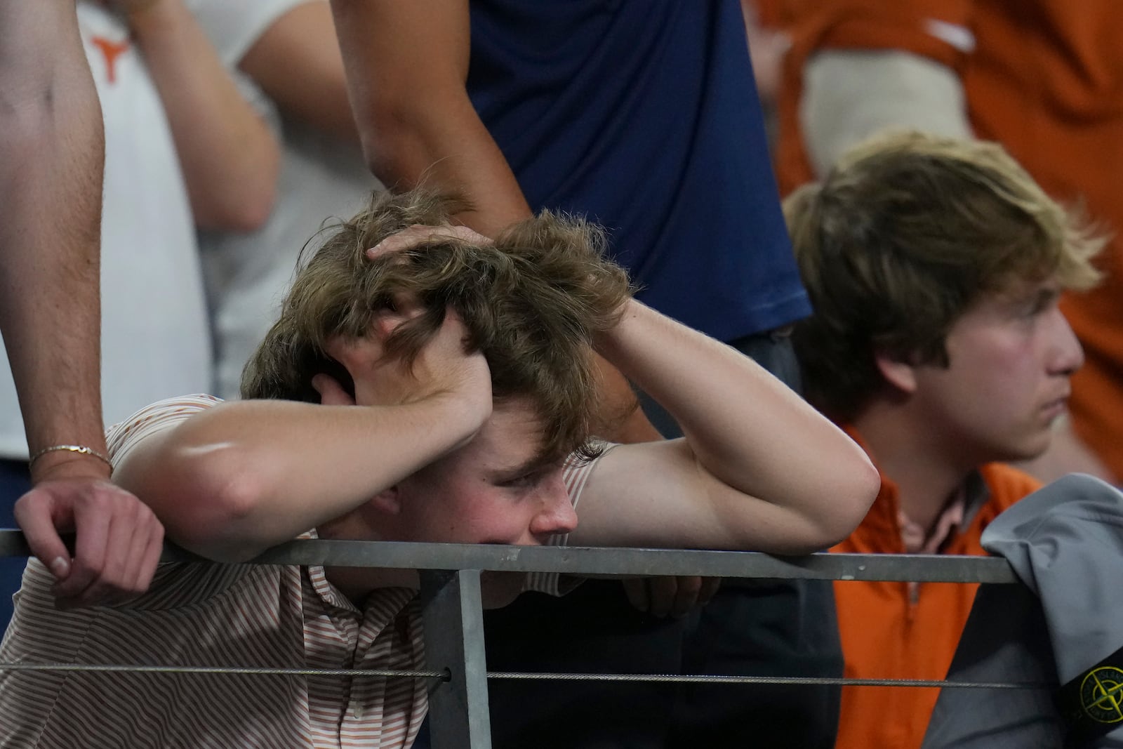 Texas fans react after Ohio State defensive end Jack Sawyer returned a fumble recover for a touchdown during the second half of the Cotton Bowl College Football Playoff semifinal game between Texas and Ohio State, Friday, Jan. 10, 2025, in Arlington, Texas. (AP Photo/Julio Cortez)