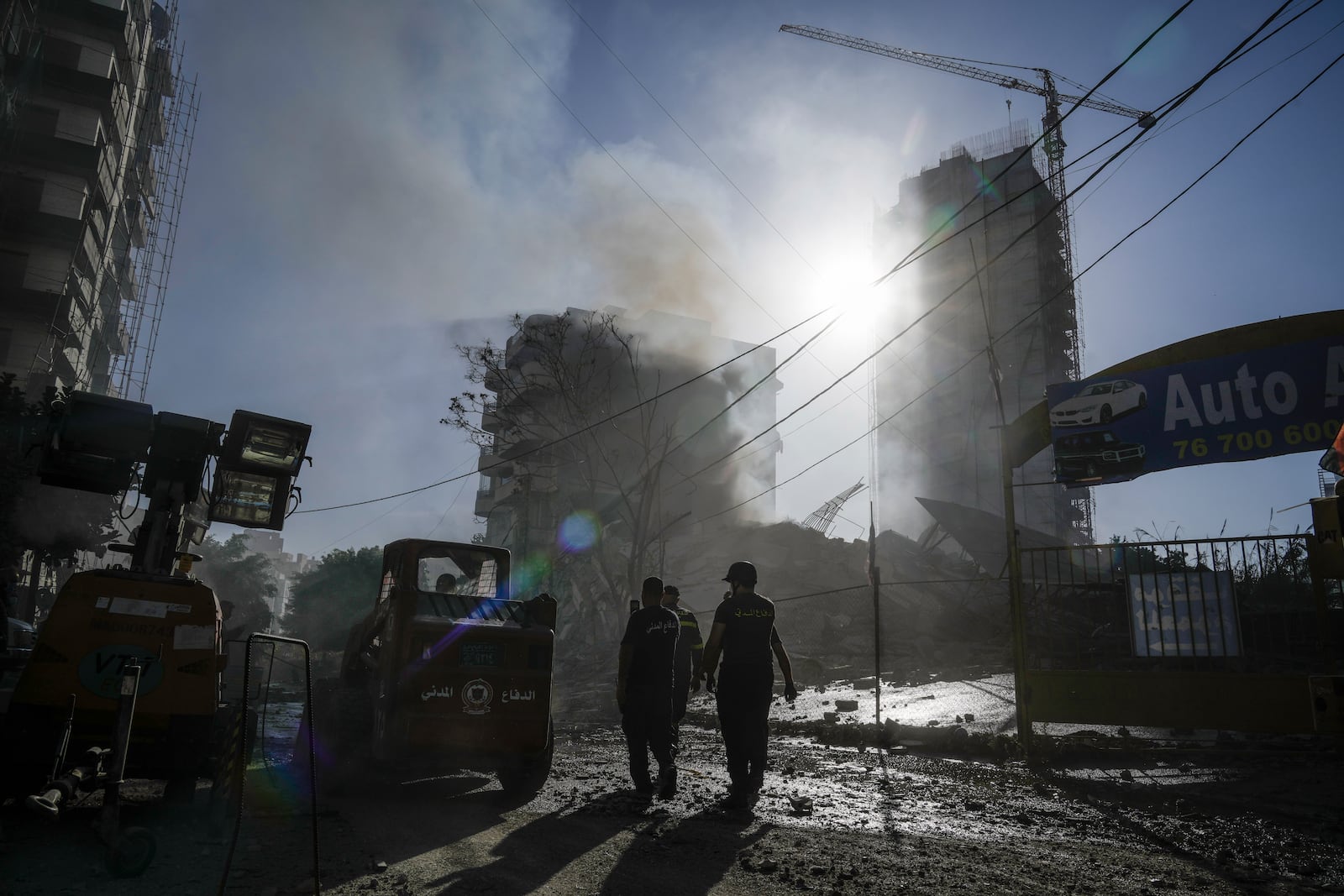 Civil defense workers check a building that collapsed after it was hit in an Israeli airstrike in Chiyah, south of Beirut, Lebanon, Sunday, Nov. 17, 2024. (AP Photo/Bilal Hussein)