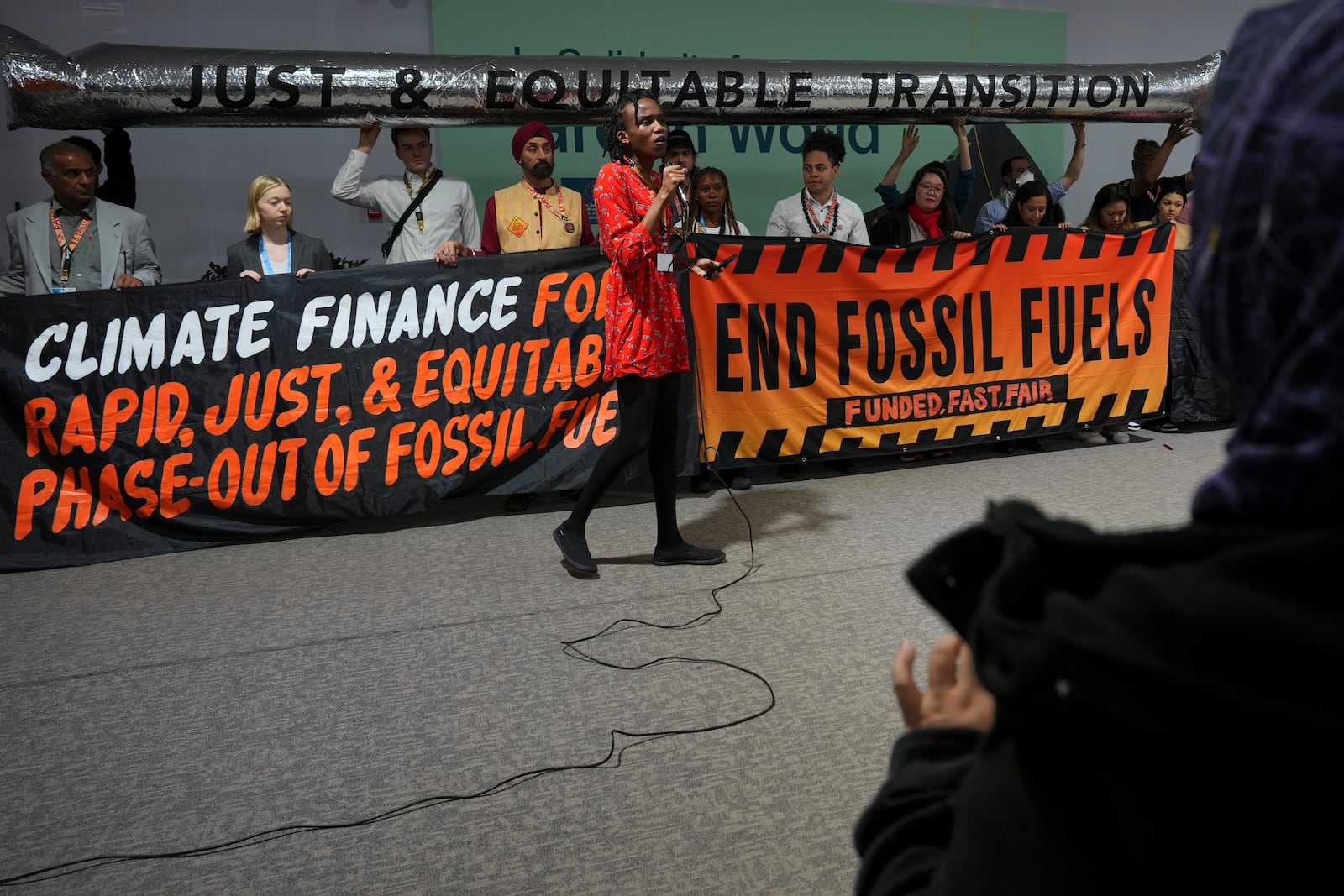 Eric Njuguna, of Kenya, participates in a demonstration against fossil fuels at the COP29 U.N. Climate Summit, Friday, Nov. 15, 2024, in Baku, Azerbaijan. (AP Photo/Peter Dejong)