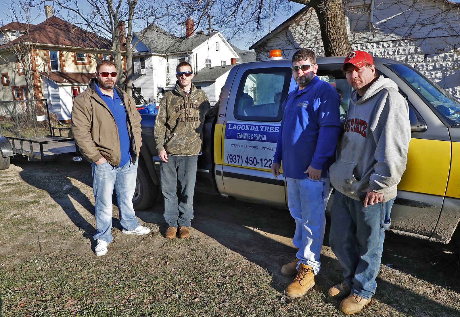 Charles Rollins, left, and his tree trimming crew, from left, Kevin Tingley, Charles Bailey and Jason Boring. Rollins, a recovering drug addict who lost his twin brother to an overdose started a recovery housing non-profit and a tree-trimming business to employ people in recovery. BILL LACKEY/STAFF