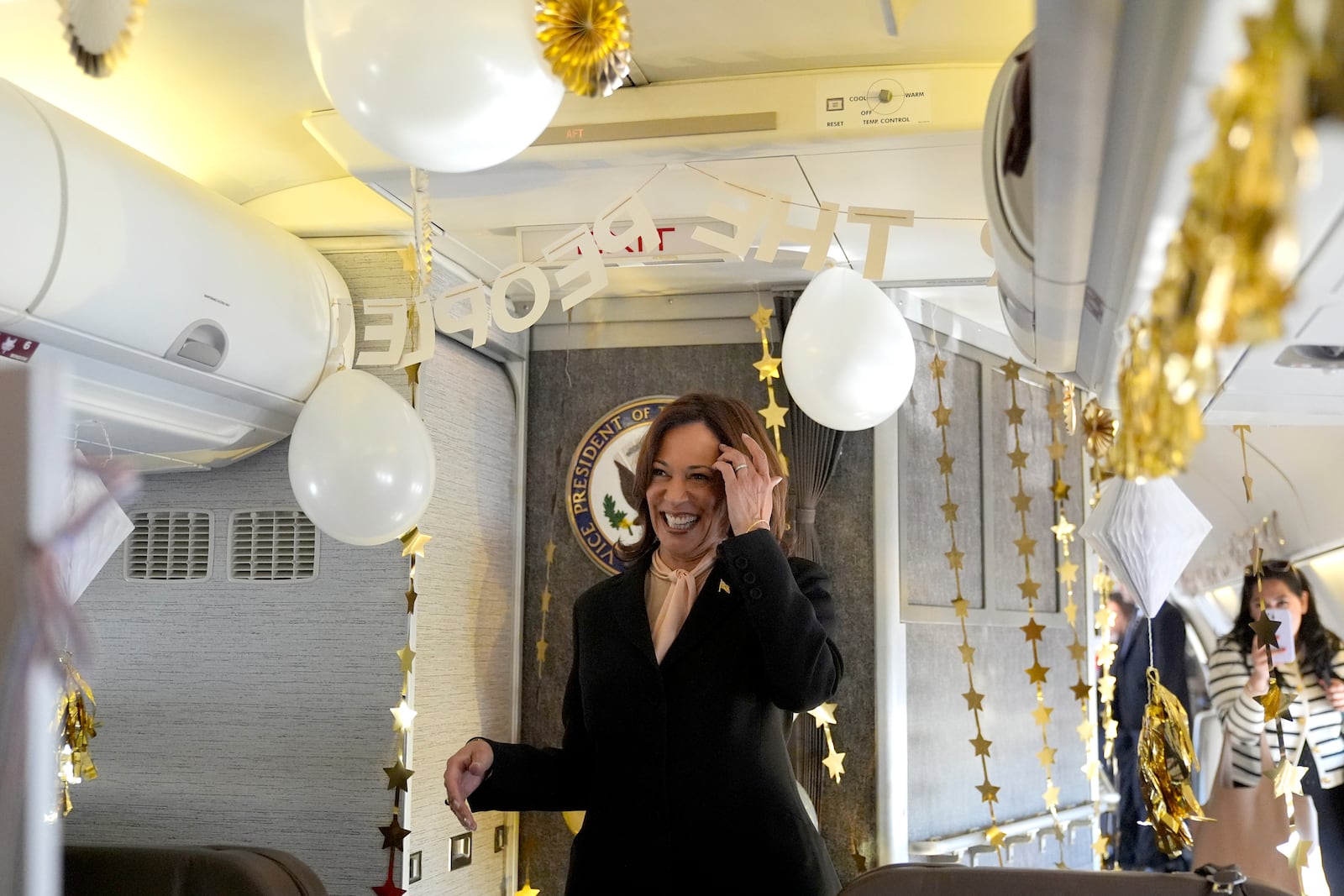 Democratic presidential nominee Vice President Kamala Harris reacts as she is surprised by campaign staff with birthday decorations on Air Force Two before departing Hartsfield Jackson International Airport in Atlanta, Sunday, Oct. 20, 2024, en route to Philadelphia. (AP Photo/Jacquelyn, Martin, Pool)