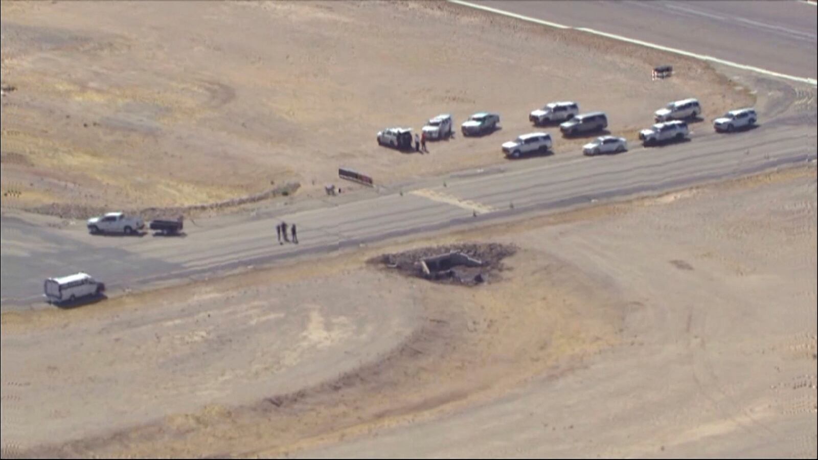 In this image taken from video, law enforcement at the site of a deadly plane crash at Marana Regional Airport after a deadly crash in Marana, Ariz., Wednesday, Feb 19, 2025. (KNXV via AP)