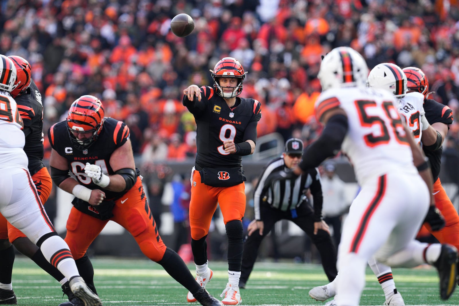 Cincinnati Bengals quarterback Joe Burrow (9) throws the ball during the first half of an NFL football game against the Cleveland Browns, Sunday, Dec. 22, 2024, in Cincinnati. (AP Photo/Jeff Dean)