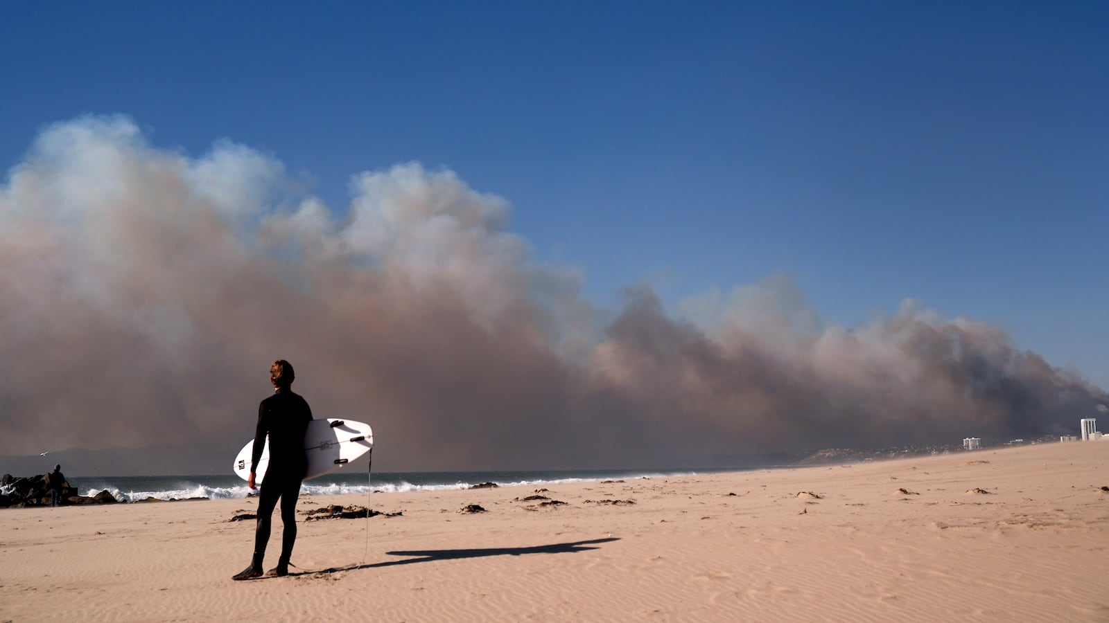 Smoke from a wildfire is seen from the Venice Beach section of Los Angeles, Tuesday, Jan. 7, 2025. (AP Photo/Jae C. Hong)