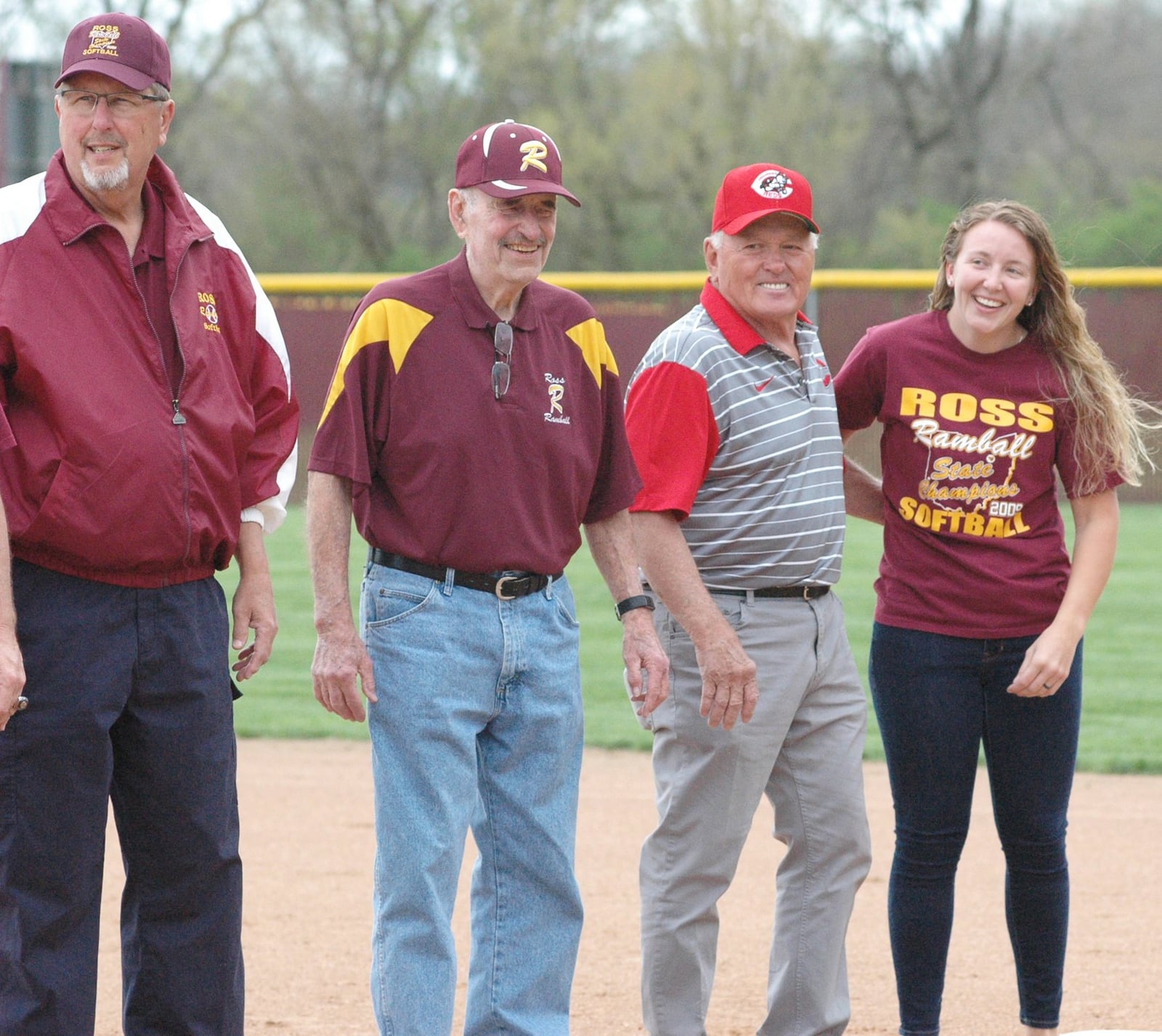 Shelby Richards (right) stands with former Ross High School coaches (from left) Jim Kernohan, Bob Walton and Gary Weitzel on Wednesday at Ross High School during a ceremony honoring the Rams’ 2009 Division II state softball champions. RICK CASSANO/STAFF