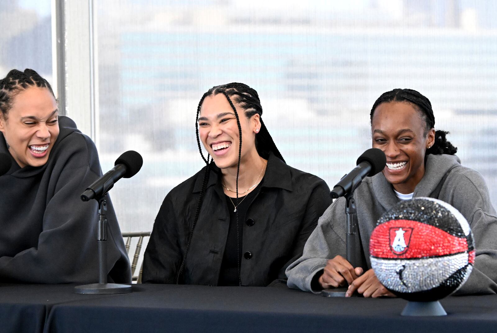 Atlanta Dream's newest players, from left, Brittney Griner, Brionna Jones and Shatori Walker-Kimbrough, react as they answer questions during a WNBA basketball news conference, Tuesday, Feb. 4, 2025, in Atlanta. (Hyosub Shin/Atlanta Journal-Constitution via AP)