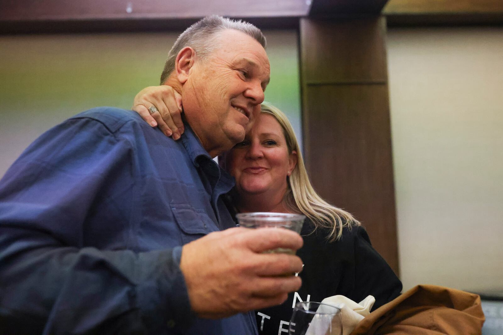 FILE - Sen. Jon Tester, D-Mont., left, receives a hug from supporter Brianne Laurin during an election night watch party, Nov. 5, 2024, in Great Falls, Mont. (AP Photo/Mike Clark, File)