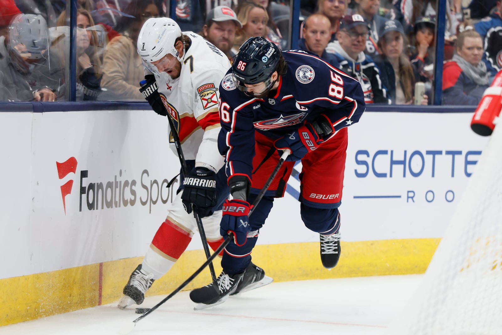 Florida Panthers' Dmitry Kulikov, left, and Columbus Blue Jackets' Kirill Marchenko fight for the puck during the second period of an NHL hockey game Tuesday, Oct. 15, 2024, in Columbus, Ohio. (AP Photo/Jay LaPrete)