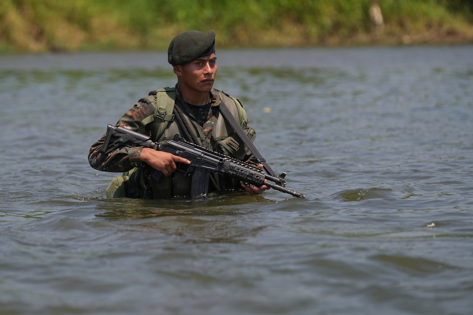 A Guatemalan soldier patrols the shared border with Mexico as part of the Ring of Fire operation, aiming to strengthen border control, at the mouth of Suchiate River in Ocos, Guatemala, Thursday, March 13, 2025. (AP Photo/Moises Castillo)