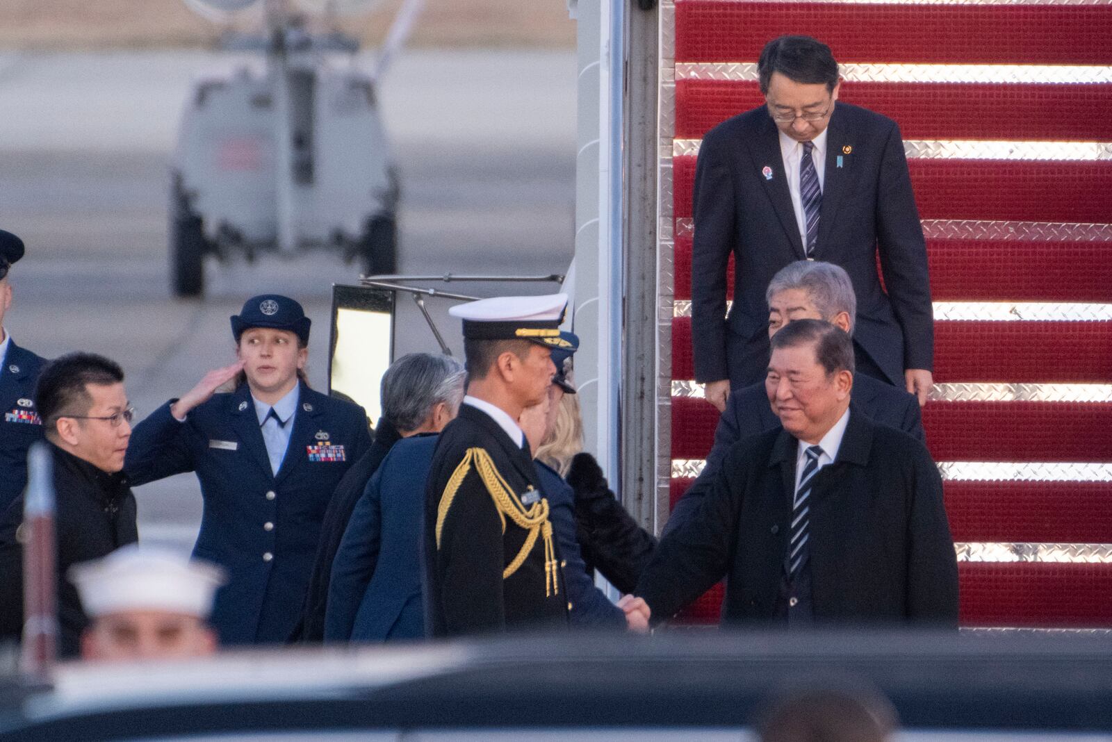 Japan's Prime Minister Shigeru Ishiba shakes hands as he is welcomed to Joint Base Andrews, Md., Thursday, Feb. 6, 2025. (AP Photo/Kevin Wolf)