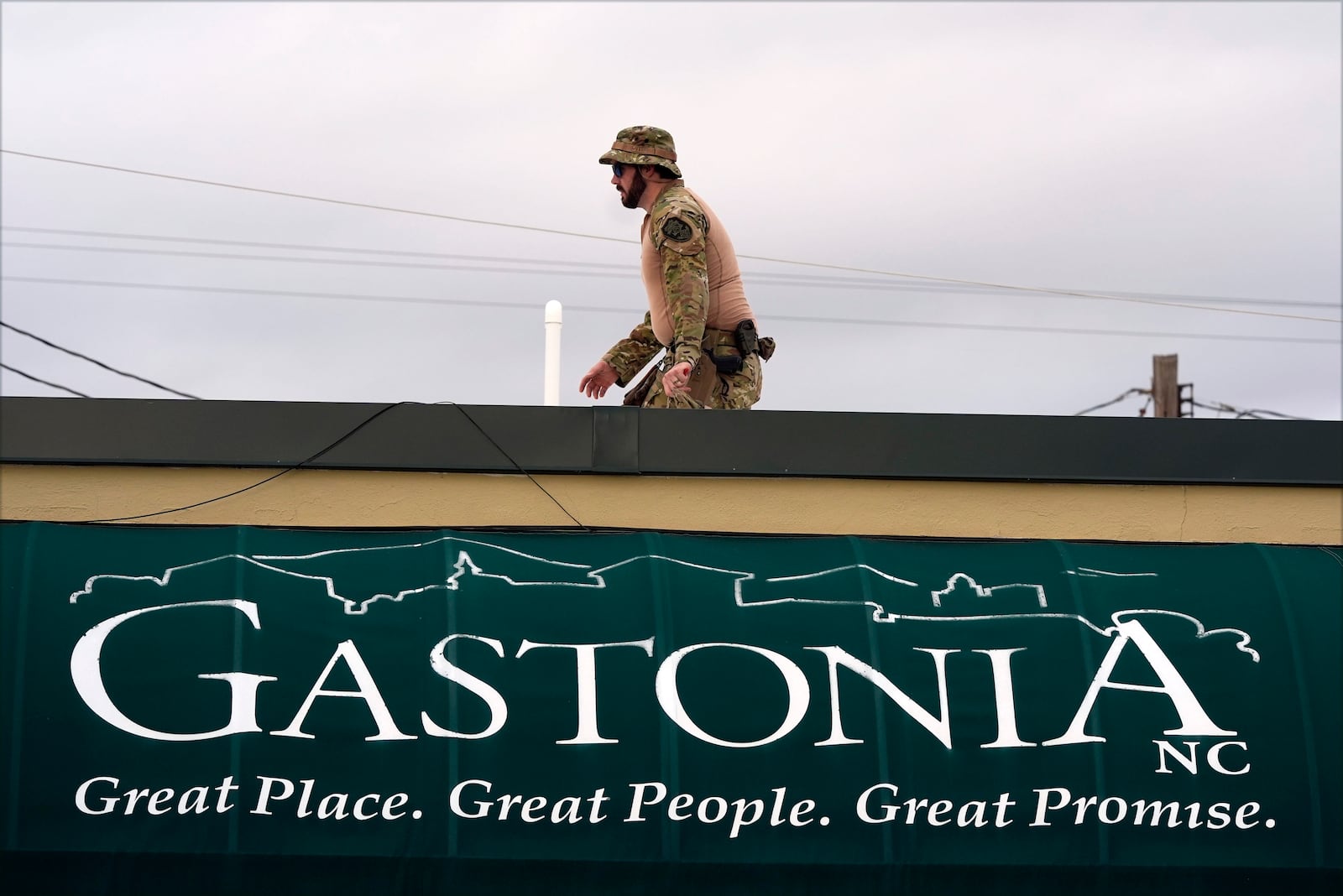 A member of law enforcement takes position before Republican presidential nominee former President Donald Trump speaks at a campaign rally in Gastonia, N.C., Saturday, Nov. 2, 2024. (AP Photo/Chris Carlson)