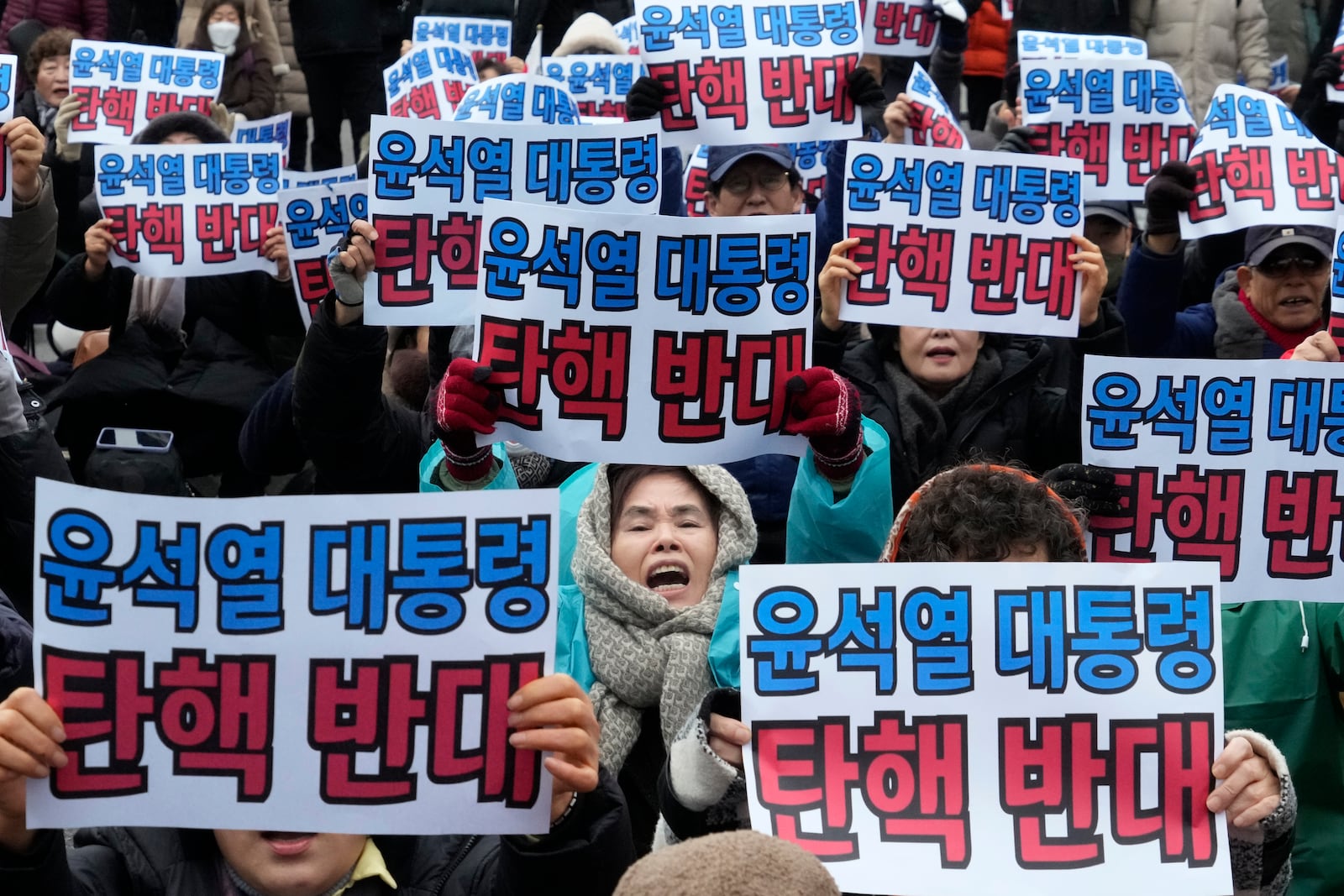 Supporters for impeached South Korean President Yoon Suk Yeol stage a rally against his impeachment near the Constitutional Court in Seoul, South Korea, Monday, Dec. 16, 2024. The signs read "Oppose the impeachment of President Yoon Suk Yeol." (AP Photo/Ahn Young-joon)