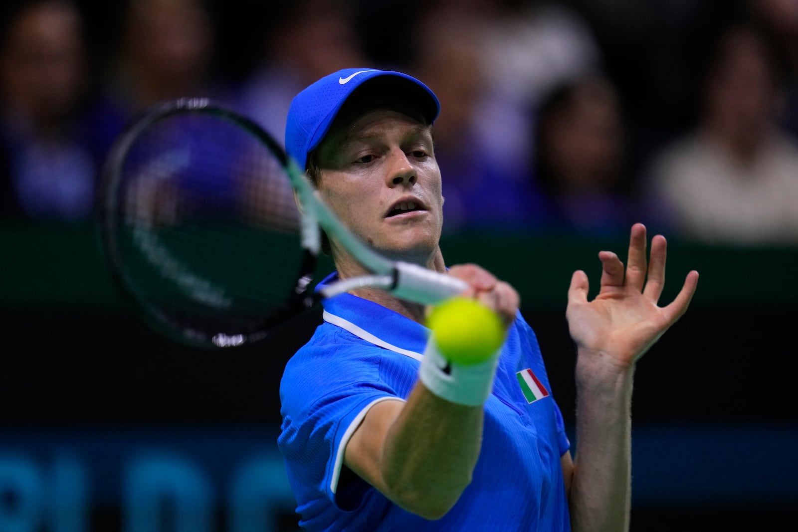 Italy's Jannik Sinner returns the ball to Netherlands' Tallon Griekspoor during the Davis Cup final tennis match between Netherlands and Italy at the Martin Carpena Sports Hall in Malaga, southern Spain, Sunday, Nov. 24, 2024. (AP Photo/Manu Fernandez)