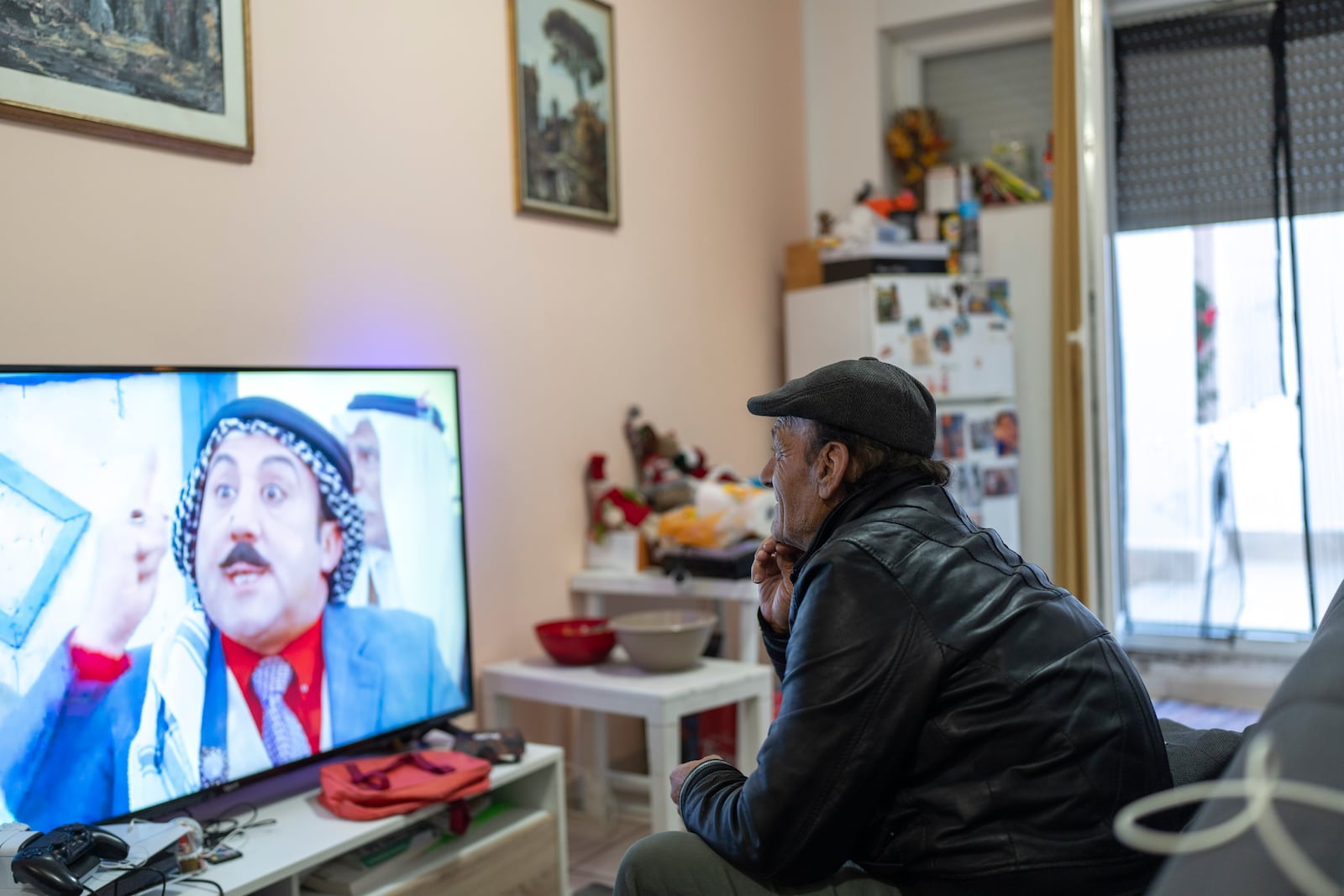 Riad Zaheda watches TV in his house in Rome, Sunday, March 2, 2025. (AP Photo/Mosa'ab Elshamy)