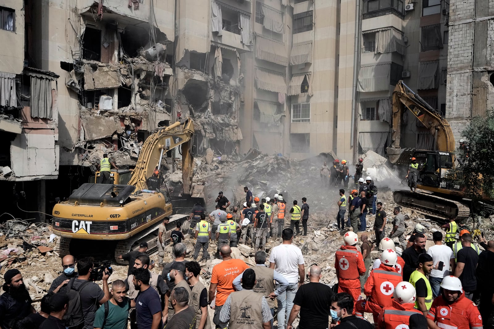 FILE - Emergency workers use excavators to clear the rubble at the site of an Israeli strike in Beirut's southern suburbs, on Sept. 21, 2024. (AP Photo/Bilal Hussein, File)