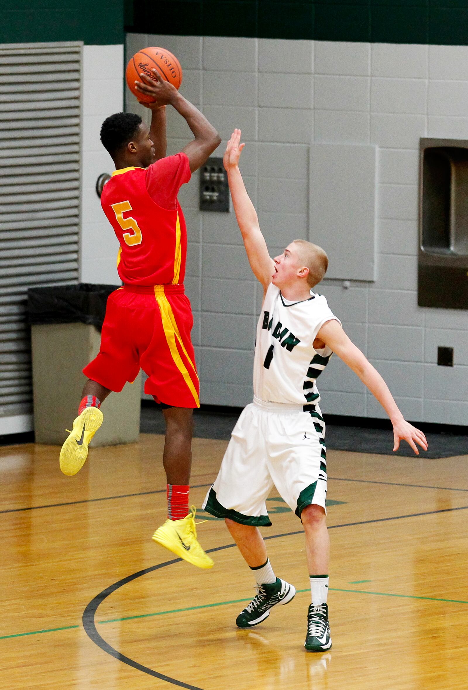 Badin’s Andrew Hetterich (1) defends Purcell Marian’s Rashaad Ali-Shakir (5) during a Jan. 7, 2014, game at Badin’s Mulcahey Gym. JOURNAL-NEWS FILE PHOTO