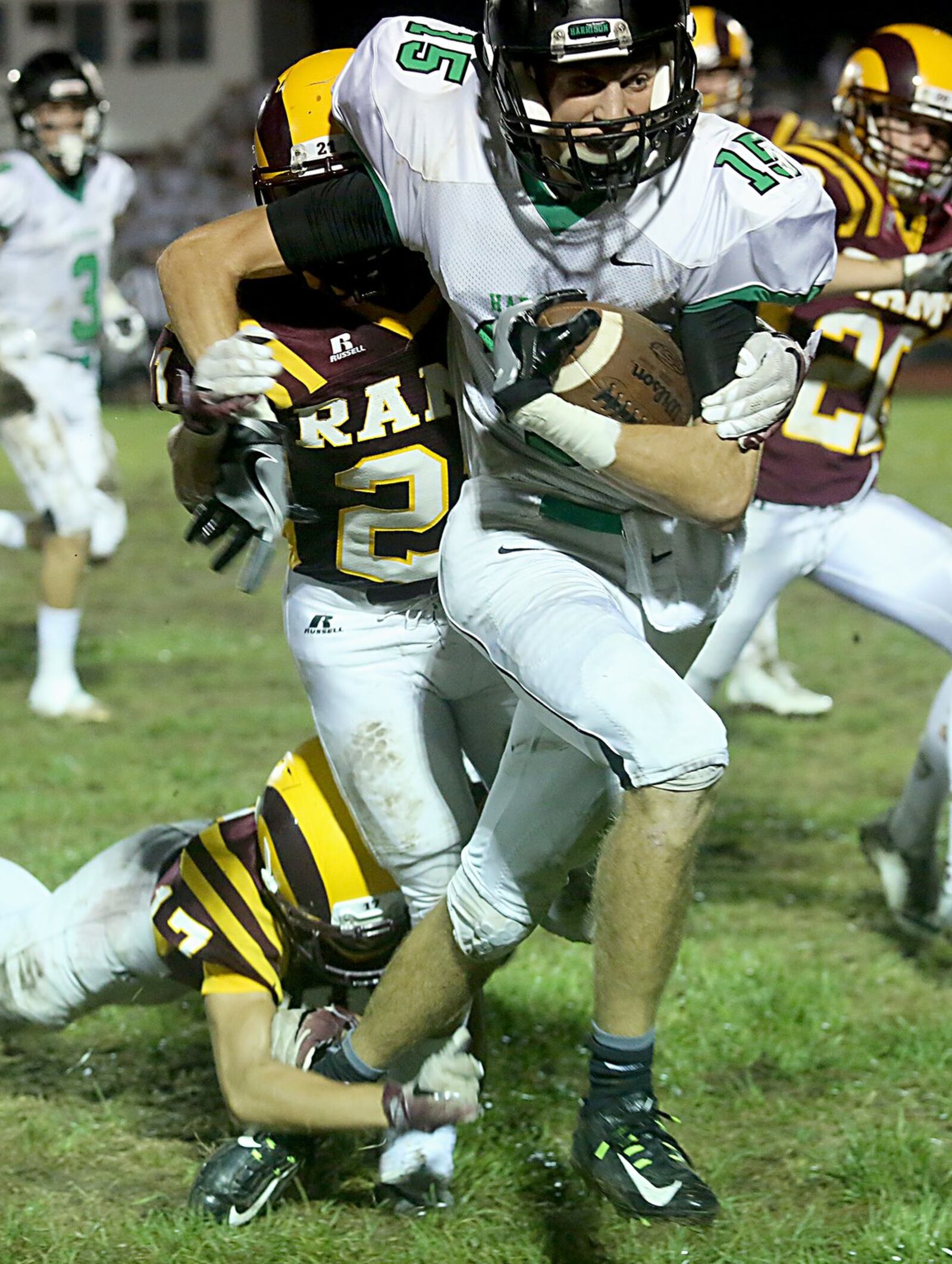 Harrison wide receiver Mitchell Crawford is brought down by Ross’ Sean Lange (17) and Jacob Brewer during their game at Ross on Sept. 16, 2016. The host Rams lost 42-7. CONTRIBUTED PHOTO BY E.L. HUBBARD