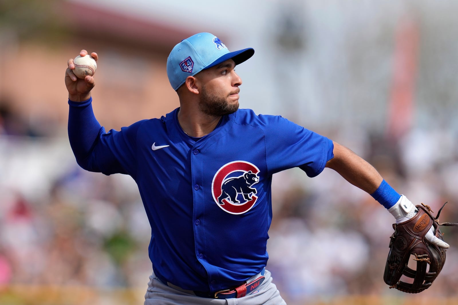 File - Chicago Cubs third baseman Nick Madrigal throws to first base to get San Francisco Giants' Patrick Bailey out during the second inning of a spring training baseball game Saturday, Feb. 24, 2024, in Scottsdale, Ariz. (AP Photo/Ross D. Franklin, File)