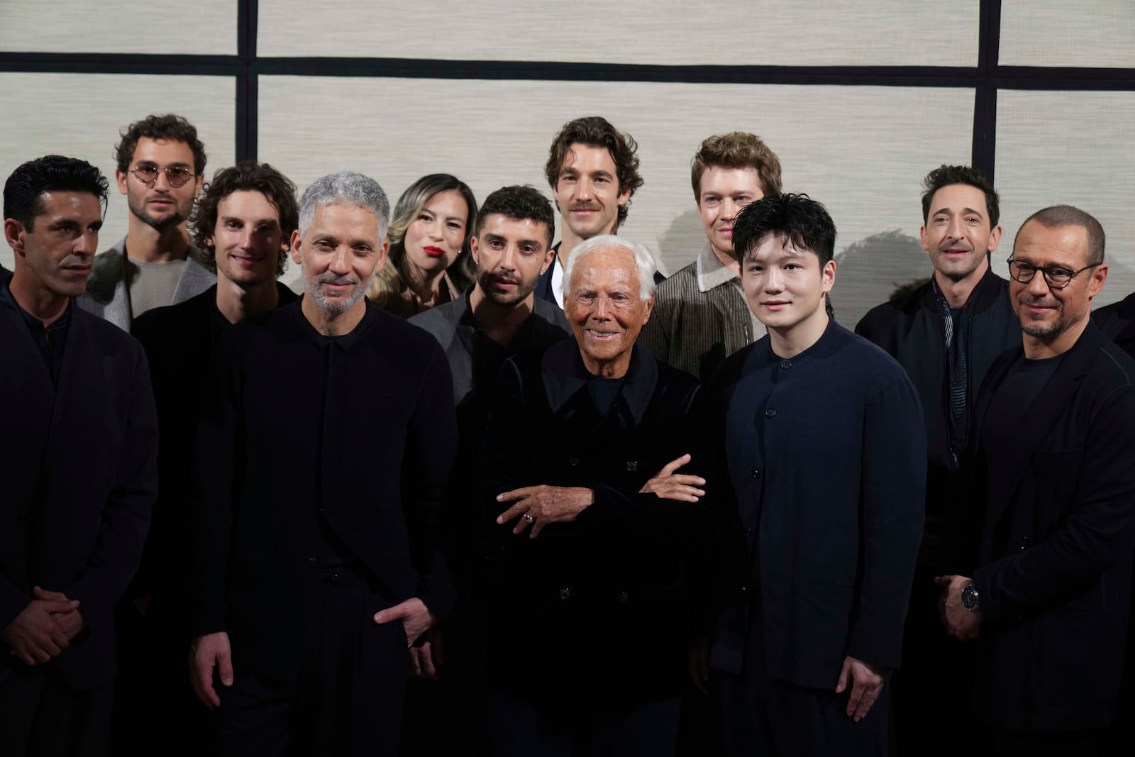 Giorgio Armani poses with guests and actors at the end of the men's Giorgio Armani Fall-Winter 2025-2026 collection, that was presented in Milan, Italy, Monday, Jan. 20, 2025. (AP Photo/Antonio Calanni)