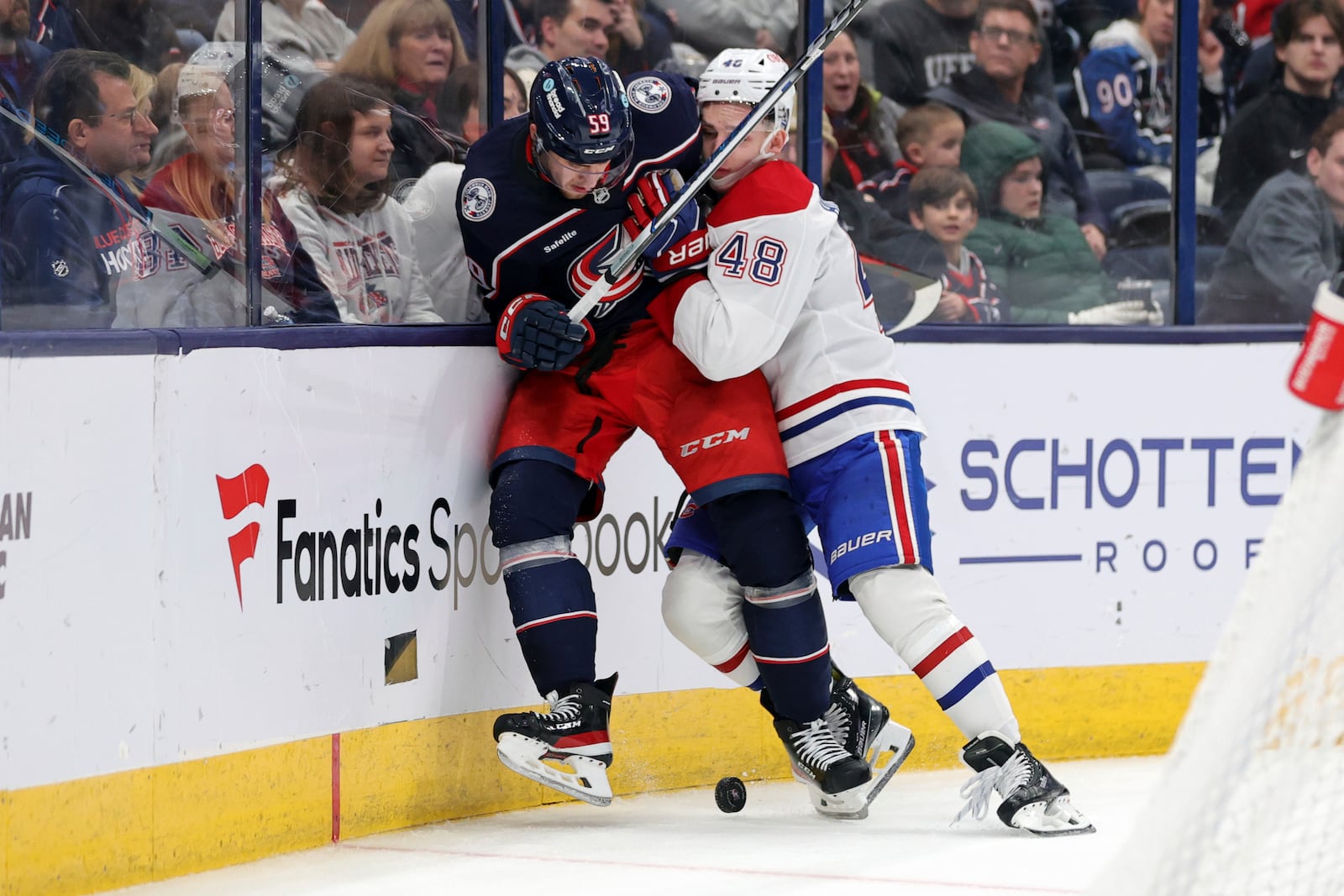 Montreal Canadiens defenseman Lane Hutson, right, checks Columbus Blue Jackets forward Yegor Chinakhov during the second period of an NHL hockey game in Columbus, Ohio, Wednesday, Nov. 27, 2024. (AP Photo/Paul Vernon)