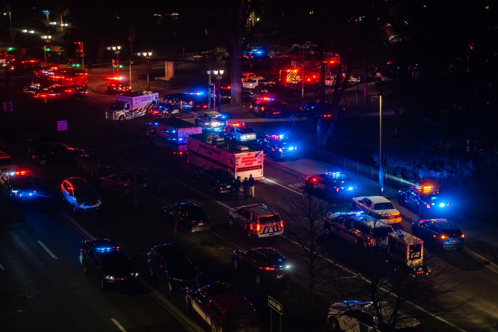 Police and emergency vehicles at Michigan State University in East Lansing late Monday night, Feb. 13, 2023, after a mass shooting. A gunman killed three people and wounded five others, all students, at Michigan State University on Monday, setting off a three-hour police manhunt and forcing students to hide in their dormitories at one of America’s largest university campuses. (Nick Hagen/The New York Times)