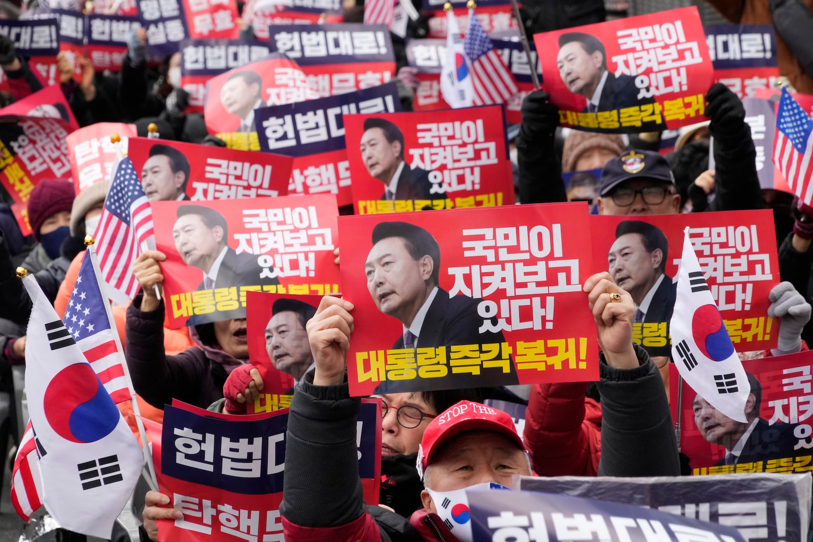 Supporters of impeached South Korean President Yoon Suk Yeol stage a rally to oppose his impeachment near the Constitutional Court in Seoul, South Korea, Tuesday, Feb. 25, 2025. The letters read "President's immediate return." (AP Photo/Ahn Young-joon)