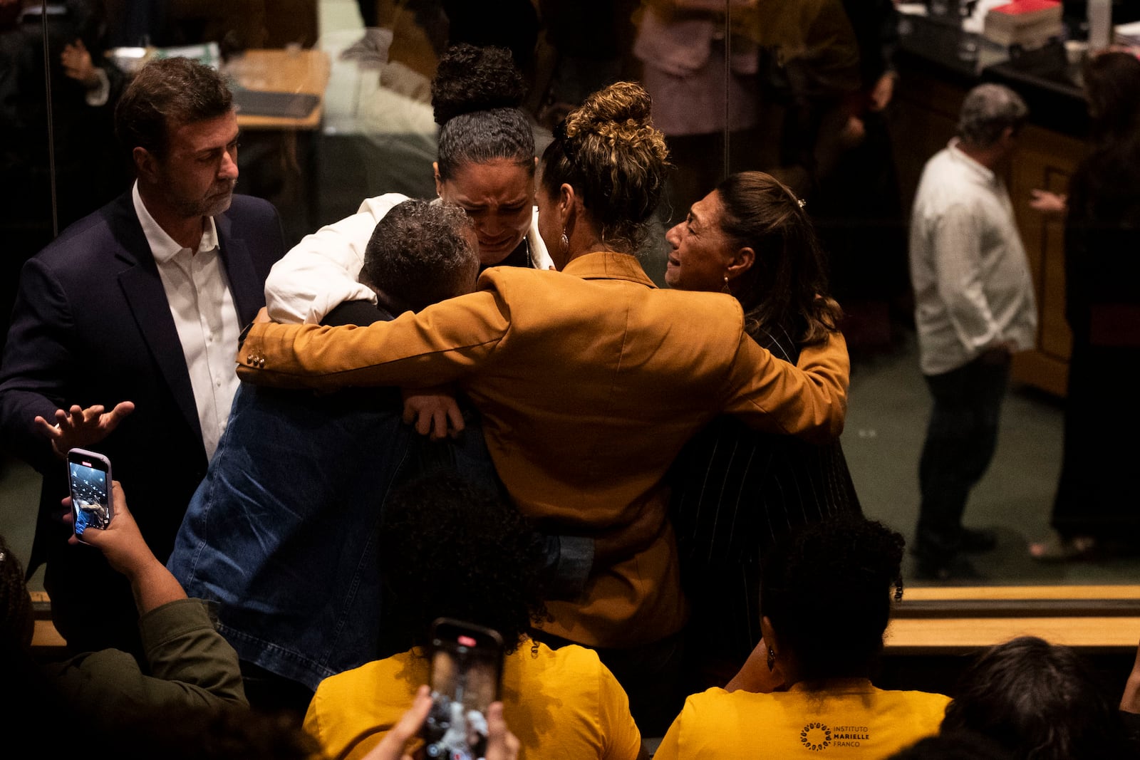 Family members of slain councilwoman Marielle Franco embrace after a judge sentenced two former police officers for the 2018 murder of Franco and her driver, at the Court of Justice in Rio de Janeiro, Thursday, Oct. 31, 2024. (AP Photo/Bruna Prado)