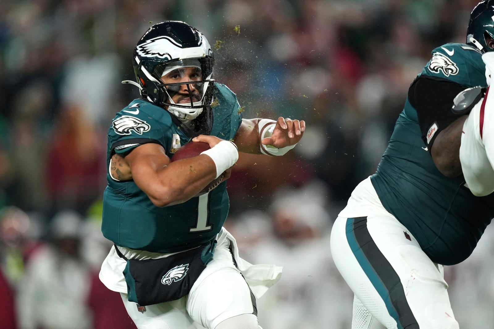 Philadelphia Eagles quarterback Jalen Hurts (1) runs with the ball during the first half of an NFL football game against the Washington Commanders Thursday, Nov. 14, 2024, in Philadelphia. (AP Photo/Matt Slocum)