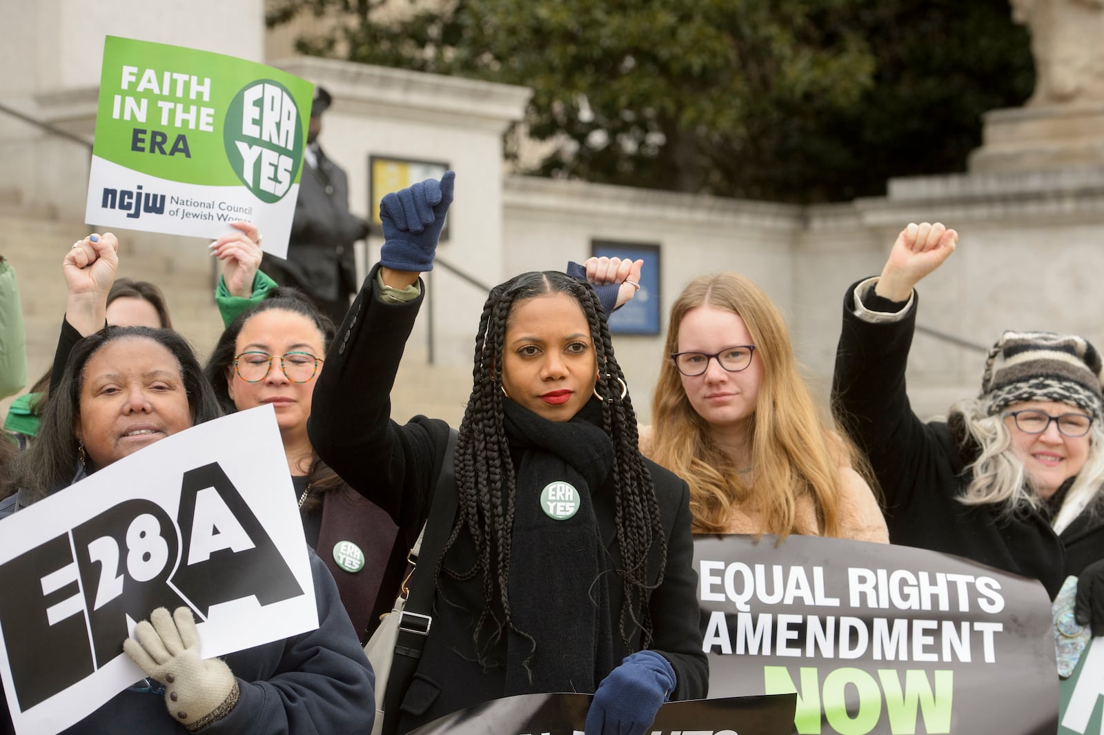 People raise their fists during a rally in front of the National Archives to highlight President Joe Biden's decision to declare the Equal Rights Amendment (ERA) as the 28th Amendment to the United States Constitution, Friday, Jan. 17, 2025, in Washington. (AP Photo/Rod Lamkey, Jr.)