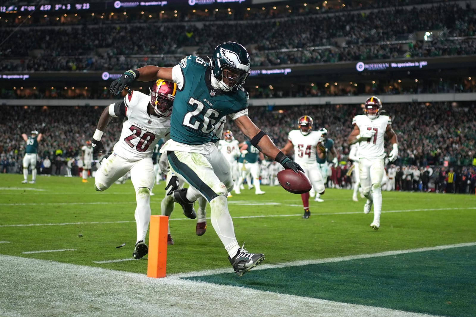 Philadelphia Eagles running back Saquon Barkley (26) scores during the second half of an NFL football game against the Washington Commanders Thursday, Nov. 14, 2024, in Philadelphia. (AP Photo/Matt Slocum)