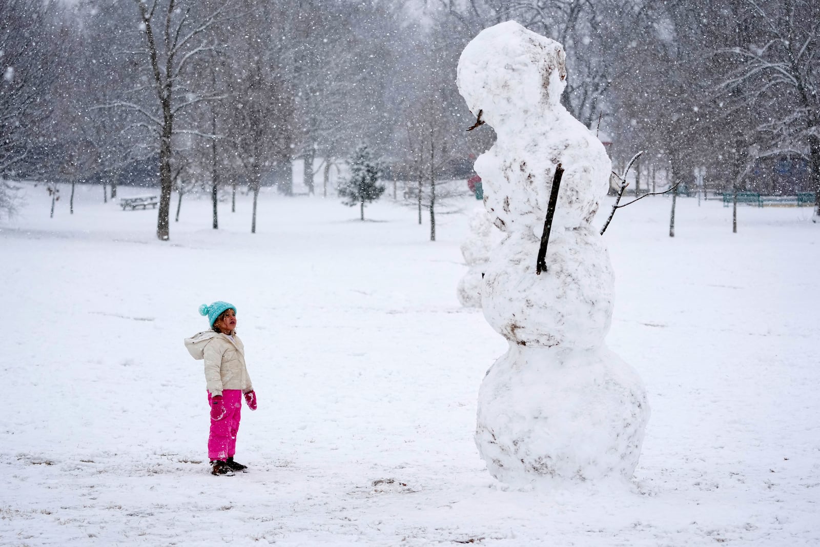 Brooklyn Brye, 4, looks up at giant snowman, Friday, Jan. 10, 2025, in Nashville, Tenn. (AP Photo/George Walker IV)