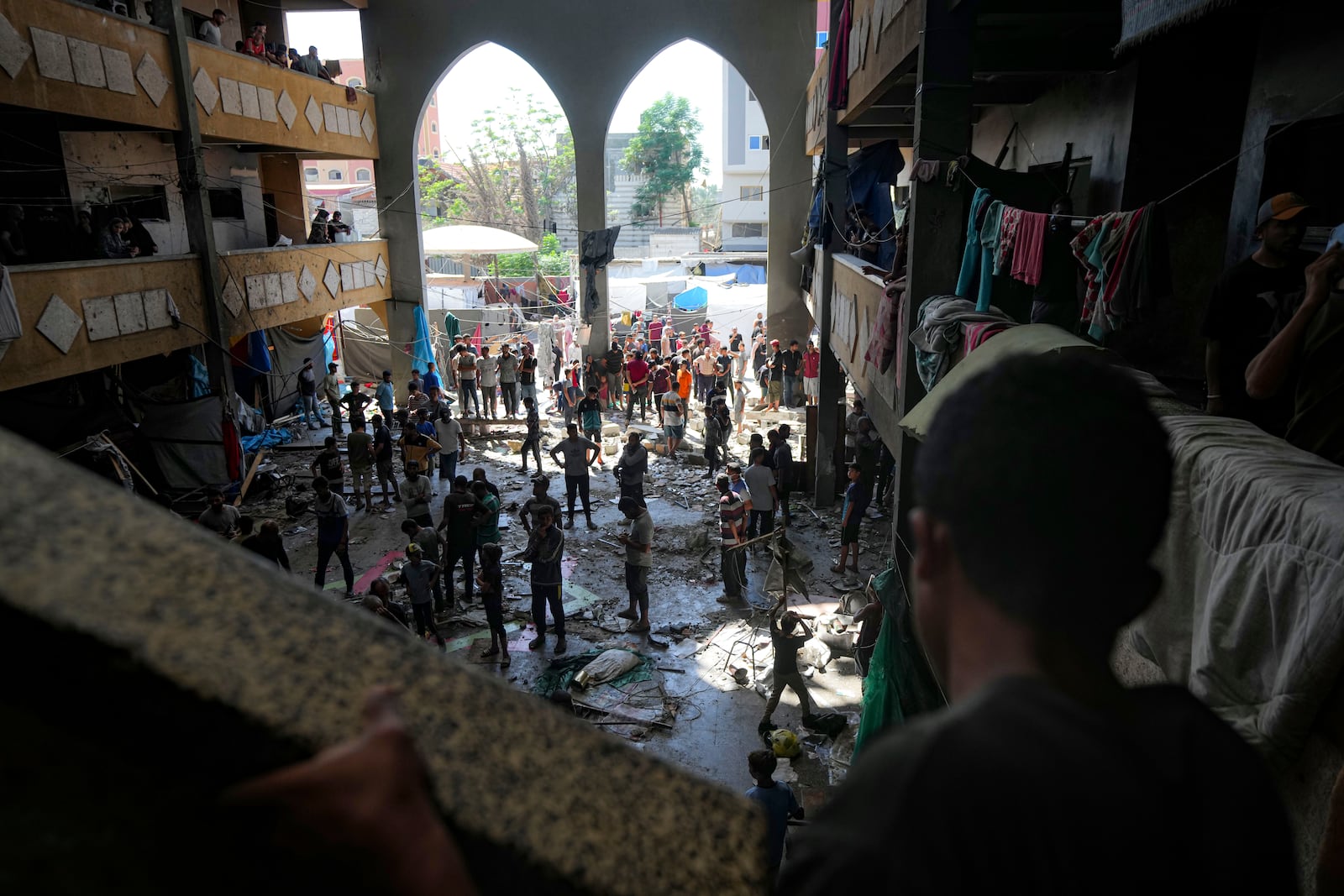 Palestinians inspect the damage of a school hit by an Israeli bombardment on Deir al-Balah, central Gaza Strip, Thursday, Oct. 10, 2024. (AP Photo/Abdel Kareem Hana)