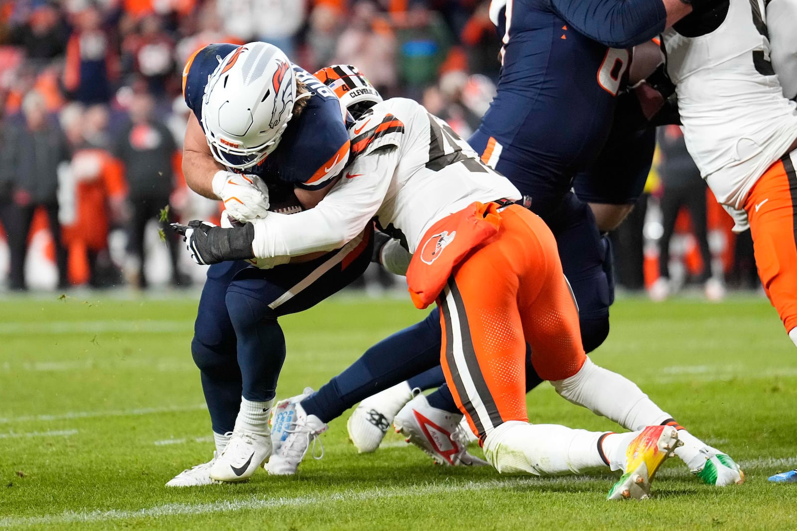 Denver Broncos fullback Michael Burton (20) breaks from Cleveland Browns linebacker Mohamoud Diabate (43) to score from 1-yard during the first half of an NFL football game, Monday, Dec. 2, 2024, in Denver. (AP Photo/Jack Dempsey)