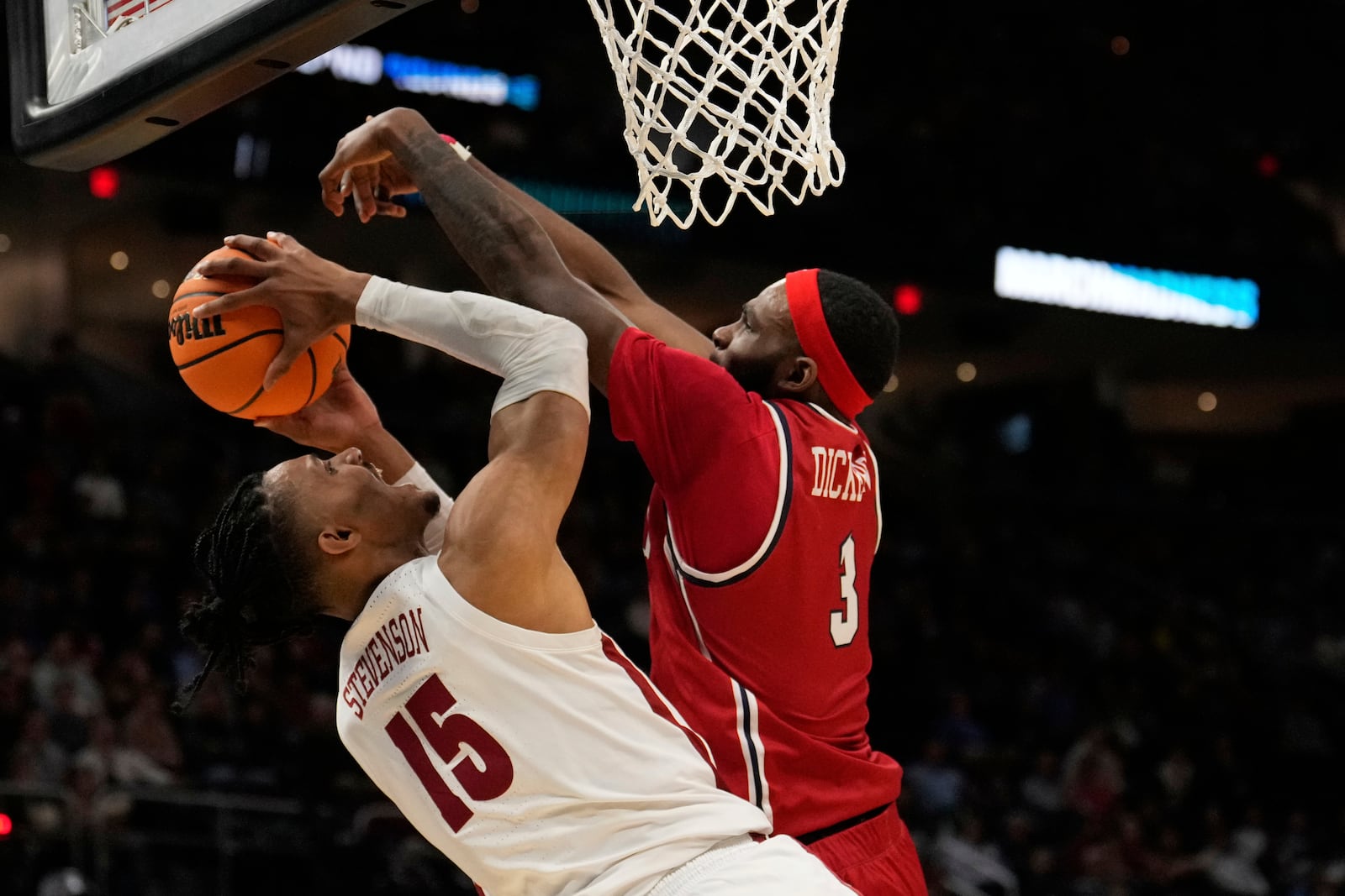 Alabama forward Jarin Stevenson (15) shoots as Robert Morris guard Amarion Dickerson (3) defends in the first half in the first round of the NCAA college basketball tournament, Friday, March 21, 2025, in Cleveland. (AP Photo/Sue Ogrocki)