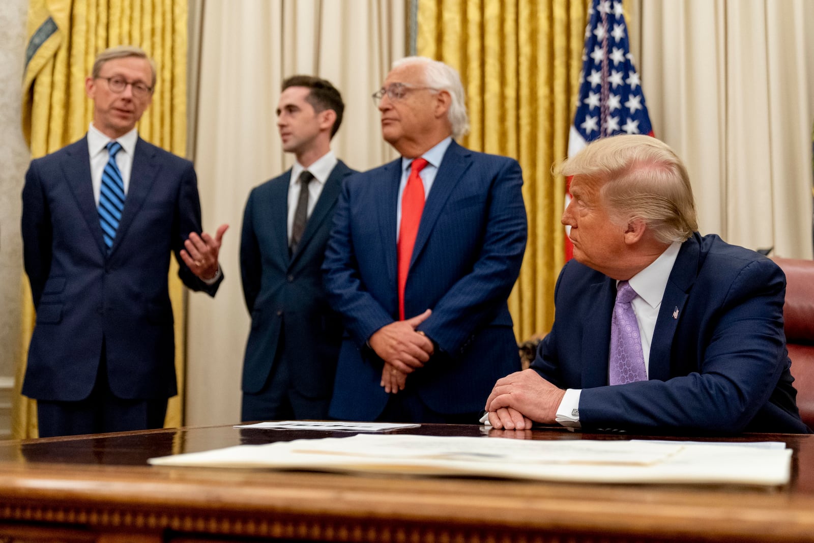 FILE - From left, U.S. special envoy for Iran Brian Hook, accompanied by from left, Avraham Berkowitz, Assistant to the President and Special Representative for International Negotiations, U.S. Ambassador to Israel David Friedman, and President Donald Trump, speaks in the Oval Office at the White House, Aug. 12, 2020, in Washington. (AP Photo/Andrew Harnik, File)