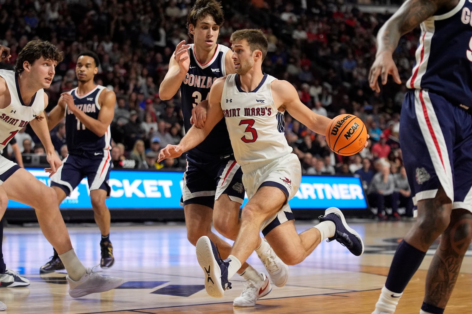 Saint Mary's guard Augustas Marciulionis (3) drives against Gonzaga forward Braden Huff (34) during the first half of an NCAA college basketball championship game in the West Coast Conference men's tournament Tuesday, March 11, 2025, in Las Vegas. (AP Photo/John Locher)