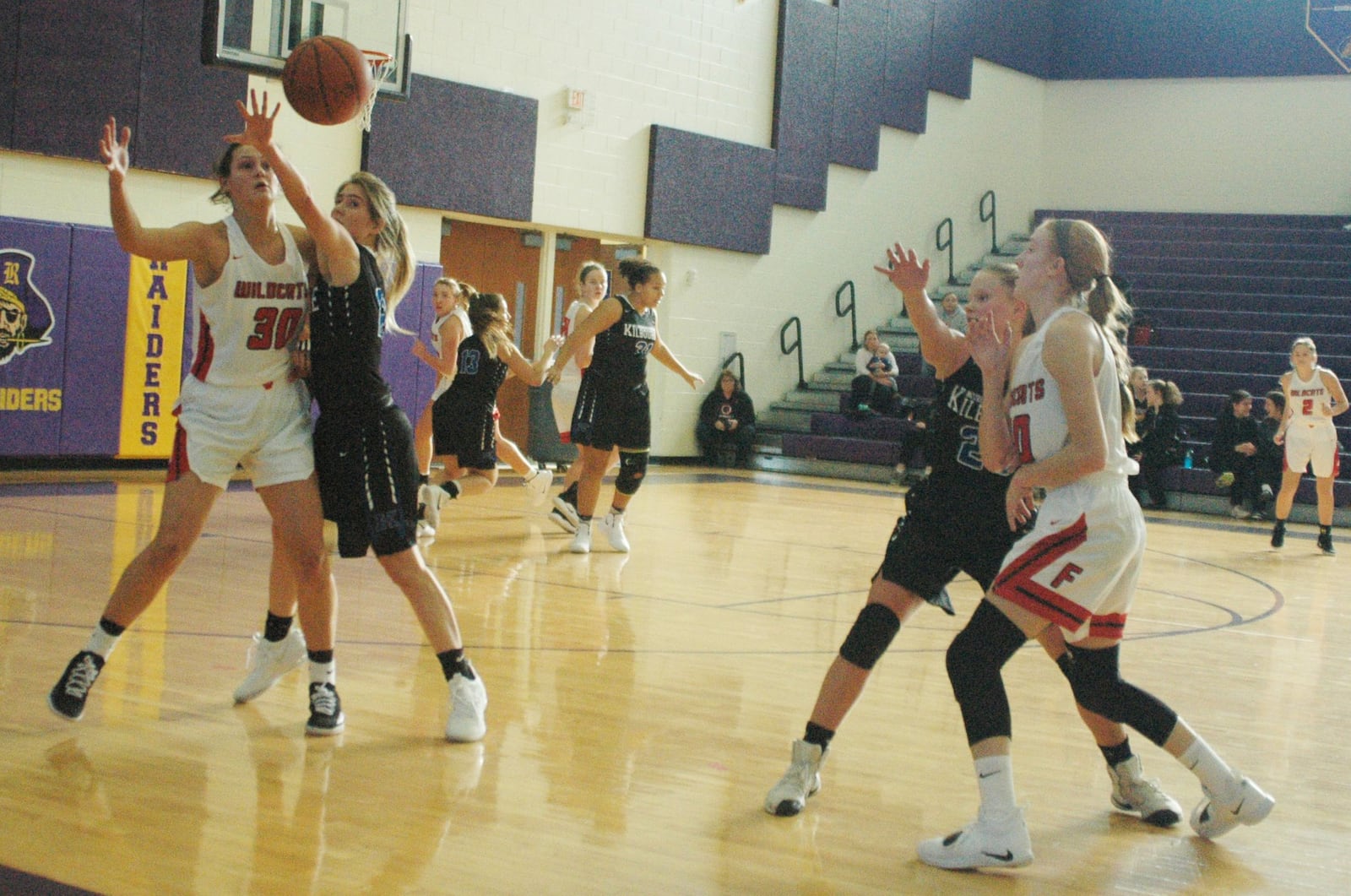 Worthington Kilbourne’s Julia Taylor (12) tries to intercept a pass intended for Franklin’s Layne Ferrell (30) on Sunday afternoon at Reynoldsburg. Franklin’s Jordan Rogers (10) threw the pass as Kilbourne’s Lauren Scott (20) applied pressure. Franklin won 45-36 in the Gary West Memorial Tipoff Classic VII. RICK CASSANO/STAFF