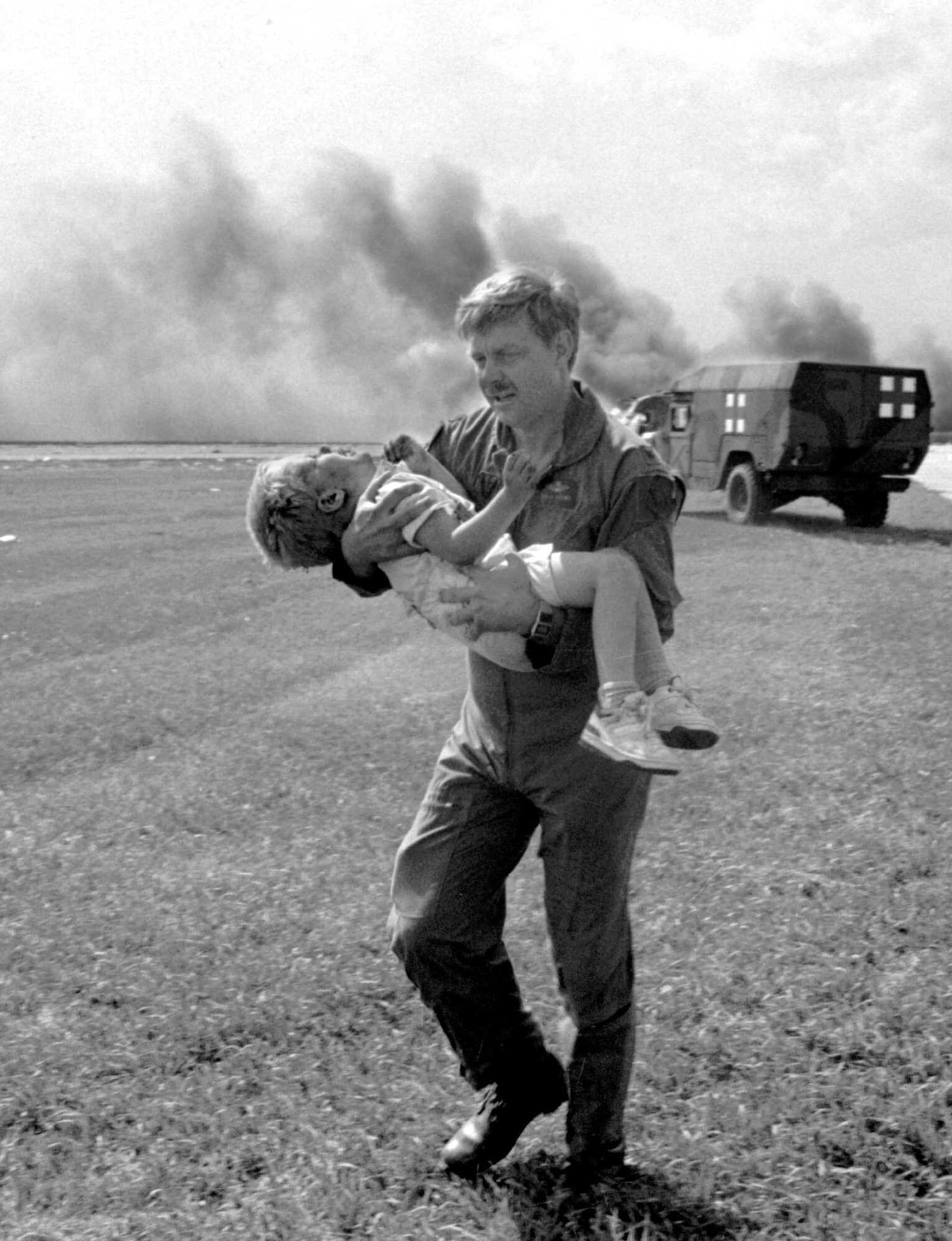 FILE- In this July 19, 1989, file photo, guardsman Dennis Nielsen carries passenger Spencer Bailey away from the wreckage of United Airlines Flight 232 after the plane crashed at Sioux Gateway Airport in Sioux City, Iowa. (Gary Anderson/Sioux City Journal via AP, File)