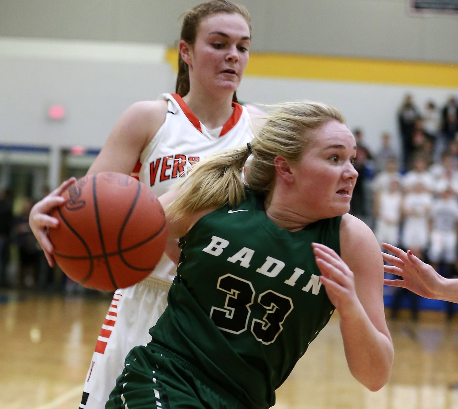 Badin’s Olivia Keene drives around Kami McEldowney of Versailles during Wednesday night’s Division III regional semifinal at Springfield. BILL LACKEY/STAFF