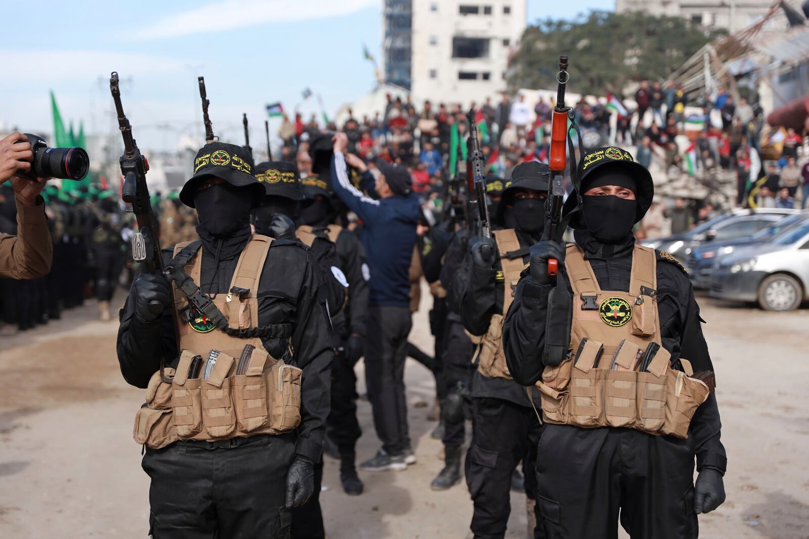 Hamas and Islamic Jihad fighters are deployed in central Gaza City ahead of the planned release of four Israeli female hostages set to be handed over to the Red Cross in Gaza City on Saturday, Jan. 25, 2025. (AP Photo/Abed Hajjar)