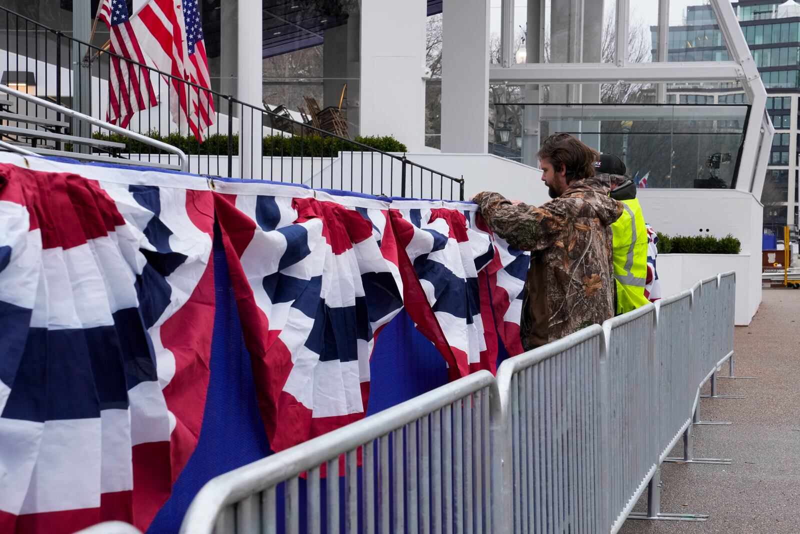 Work continues near the presidential reviewing stand on Pennsylvania Avenue outside the White House, Friday, Jan. 17, 2025, in Washington, ahead of President-elect Donald Trump's inauguration. (AP Photo/Jon Elswick)