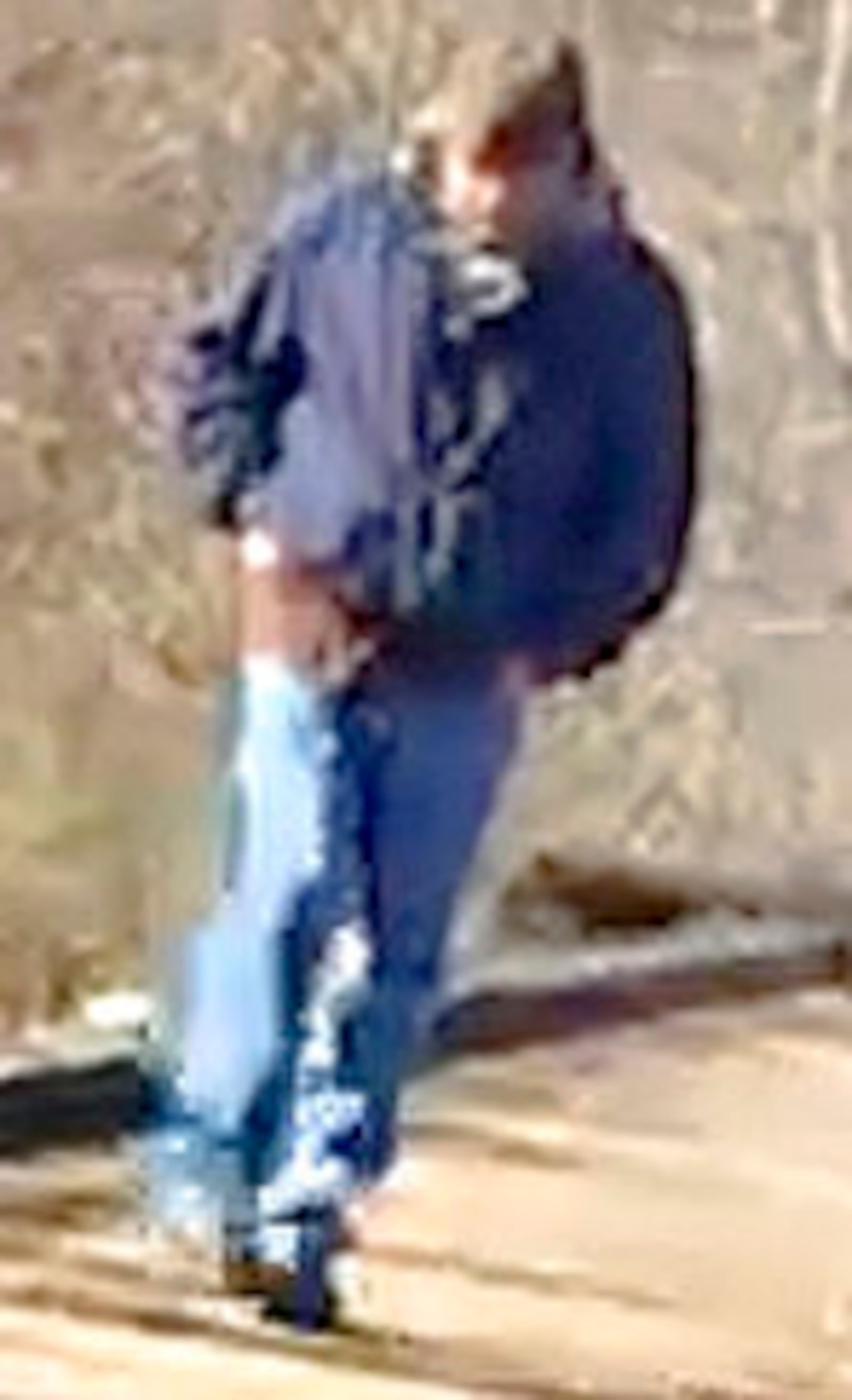 FILE - This Feb. 13, 2017, file photo released by the Indiana State Police shows a man walking along the trail system in Delphi, Ind., authorities say is the suspect in the killings of two teenage girls. Indiana State Police released a composite sketch Monday, July 17, 2017, of the suspect. (Indiana State Police via AP, File)