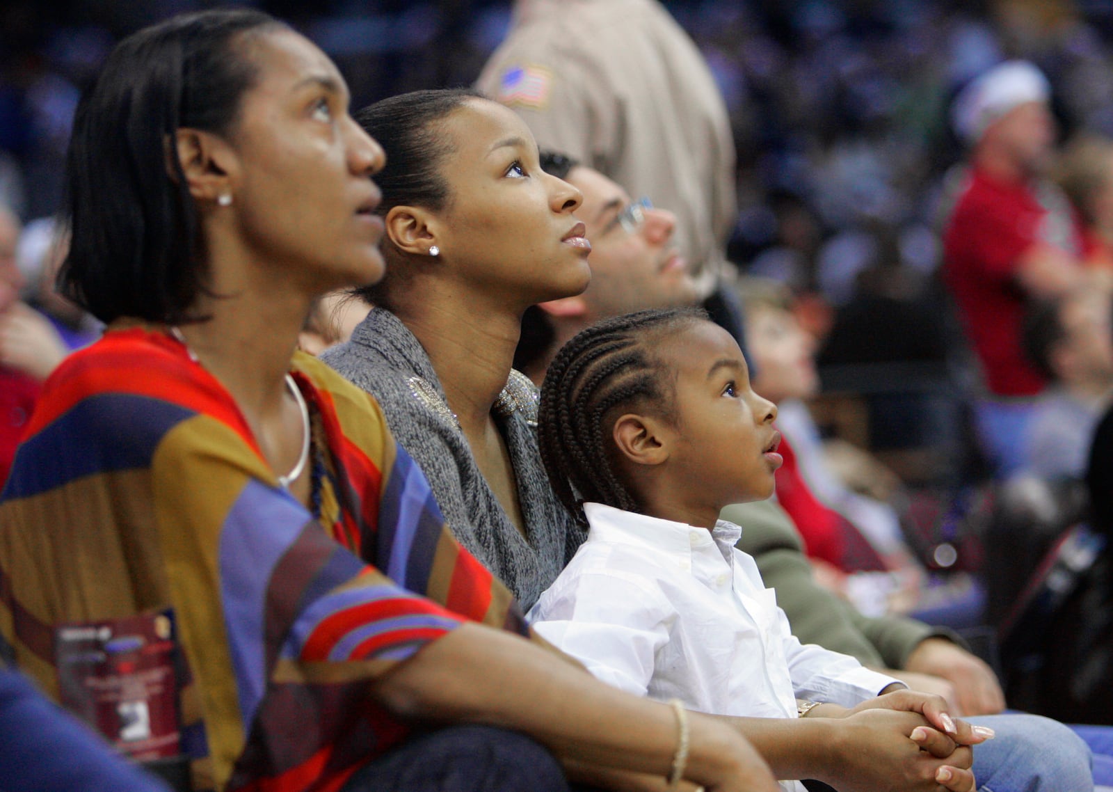 FILE - LeBron James Jr., right, watches the Cleveland Cavaliers play the Miami Heat with his mother, Savannah Brinson, center, and grandmother Gloria James, left, during an NBA basketball game Tuesday, Dec. 25, 2007, in Cleveland. (AP Photo/Mark Duncan, File)