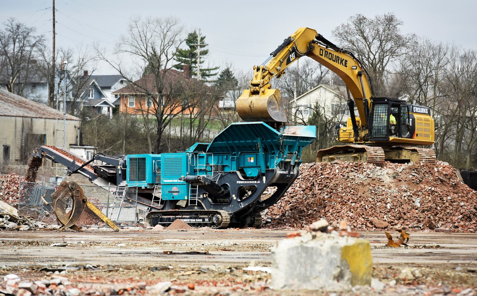 Crews load piles of bricks a machine to pulverize bricks at the former Champion Mill and future Spooky Nook Sports location on B Street Friday, April 5 in Hamilton. NICK GRAHAM/STAFF