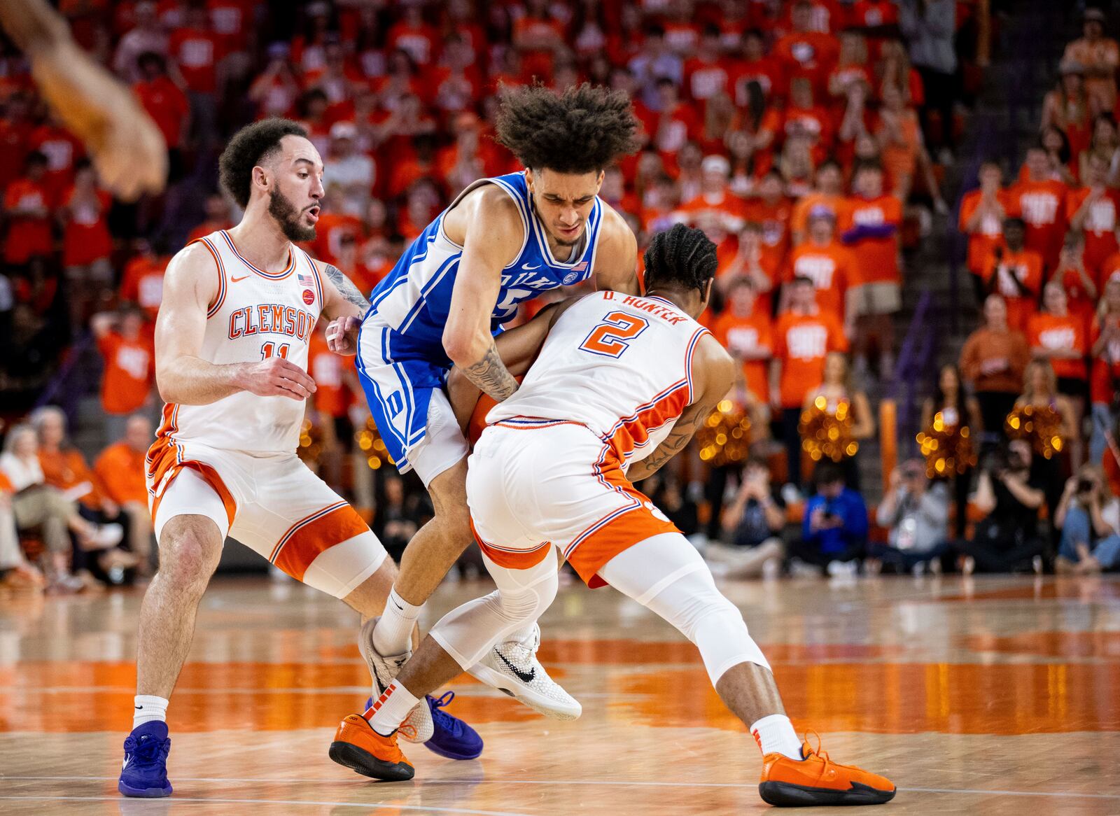 Clemson guard Dillon Hunter (2) ties up the ball with Duke guard Tyrese Proctor (5) during the first half of an NCAA college basketball game on Saturday, Feb. 8, 2025, in Clemson, S.C. (AP Photo/Scott Kinser)