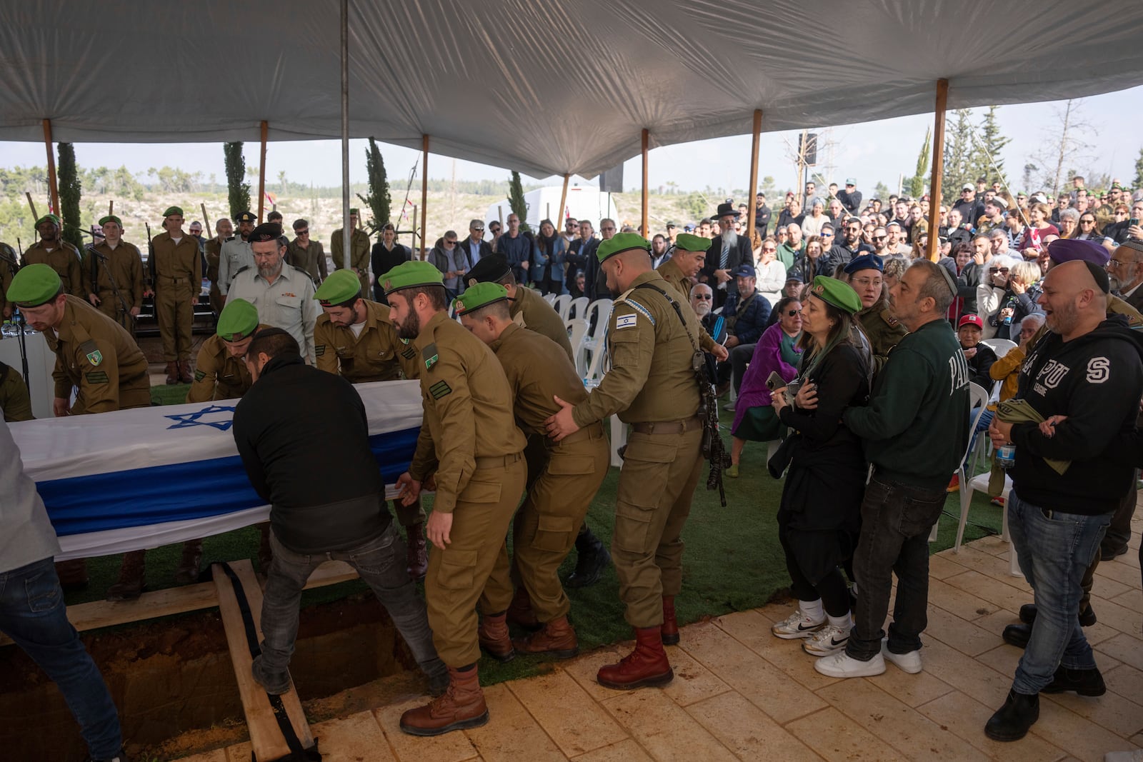 Israeli soldiers and relatives carry the flag-draped casket of Sergeant Yahav Maayan, who was killed in combat in the Gaza Strip, during his funeral at a military cemetery in Modiin, Israel, Sunday, Jan. 12, 2025. (AP Photo/Ohad Zwigenberg)