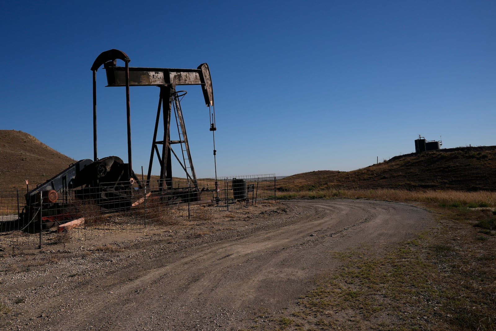 FILE - A pumpjack works in a pasture, Sept. 30, 2024, near Hays, Kan. (AP Photo/Charlie Riedel, File)