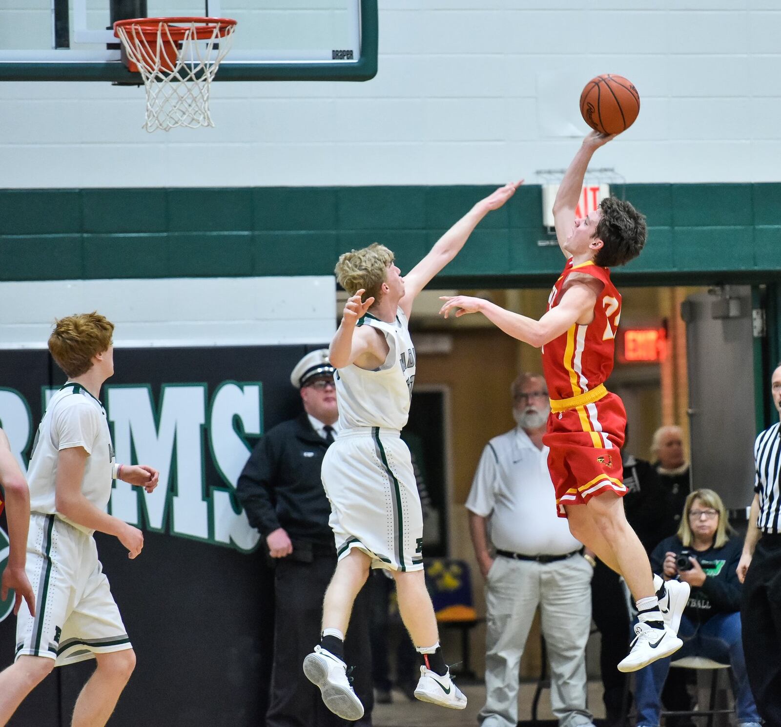 Fenwick’s David Luers puts up a shot over Badin’s Kyle Young during Friday night’s game at Mulcahey Gym in Hamilton. NICK GRAHAM/STAFF