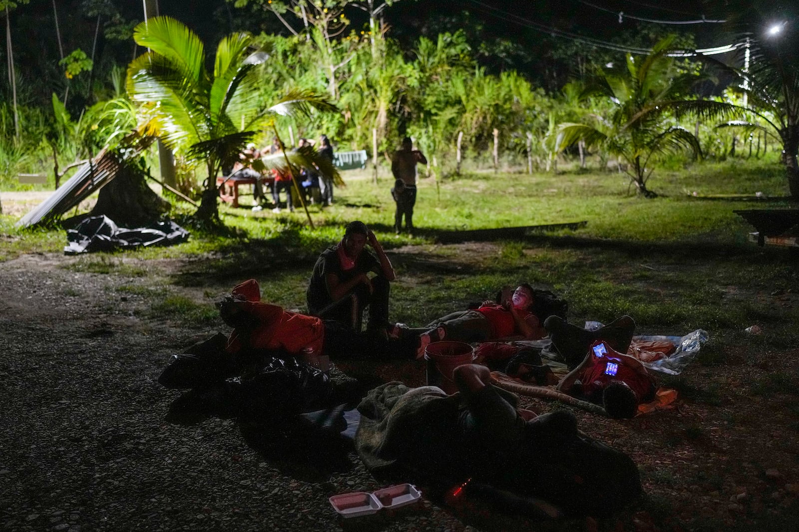 Venezuelan migrants spend the night in Puerto Carti, on Panama's Caribbean coast, Saturday, Feb. 22, 2025, before boarding boats to Colombia after turning back from southern Mexico where they gave up hopes of reaching the U.S. amid President Trump's crackdown on migration. (AP Photo/Matias Delacroix)